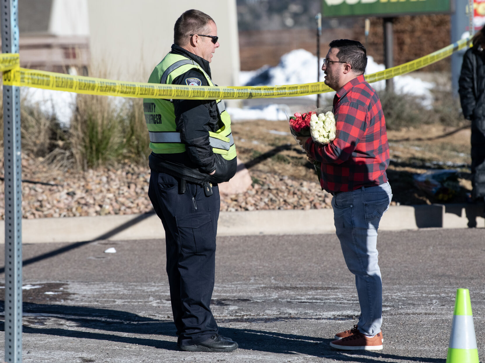 Jace Khosla, right, talks to an officer outside of Club Q where a mass shooting took place late on Saturday, Nov. 19. (The Gazette, Parker Seibold) (Parker Seibold)