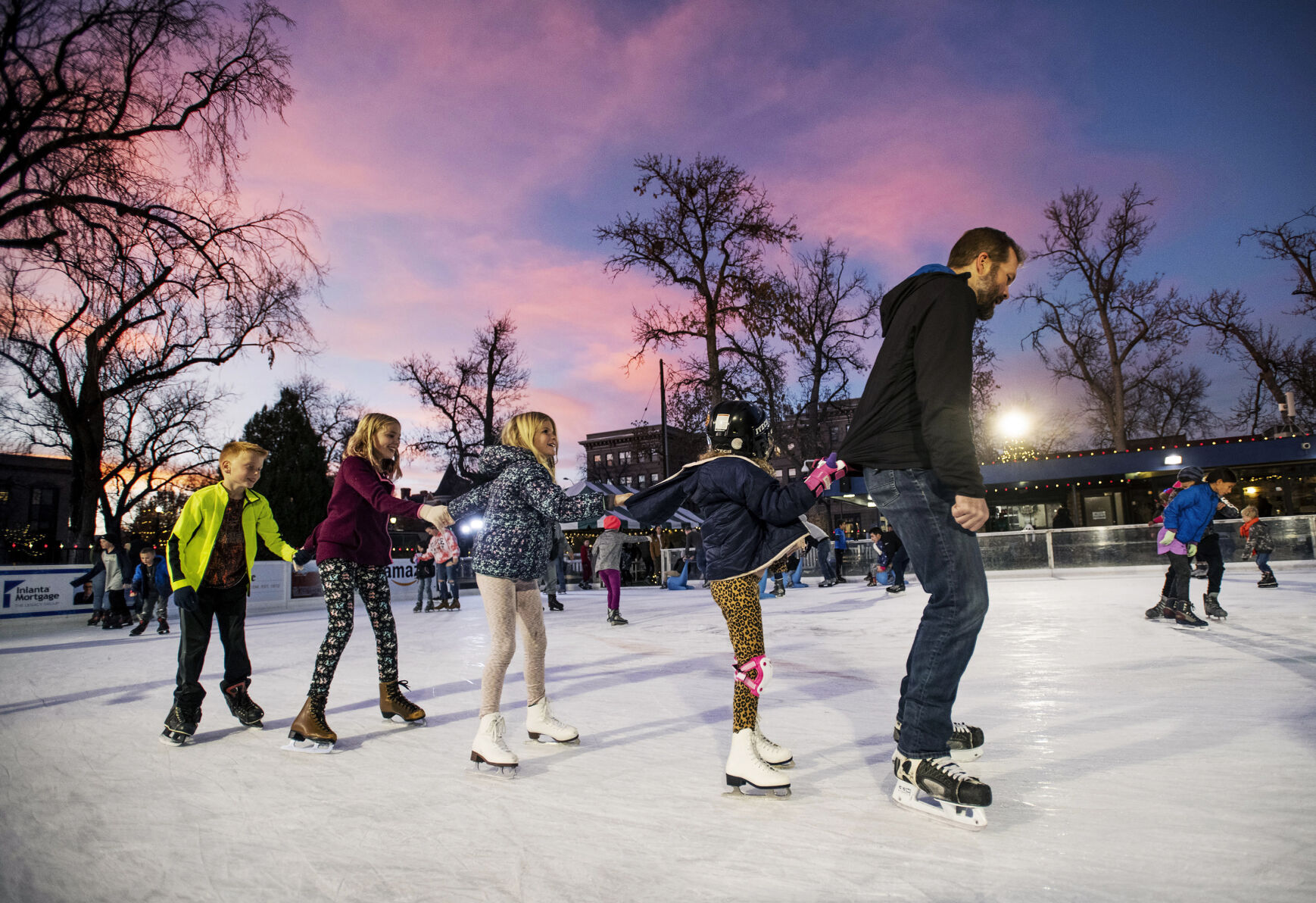 PJ Hollenbeck leads a skate train with Peia Hollenbeck, Clemmy Hollenbeck, Ashlynn Fabos-Olsen and Riley Fabos-Olsen during opening night of Skate in the Park at Acacia Park in downtown Colorado Springs on Friday, Nov. 12, 2021. Gazette file (Chancey Bush/ The Gazette)