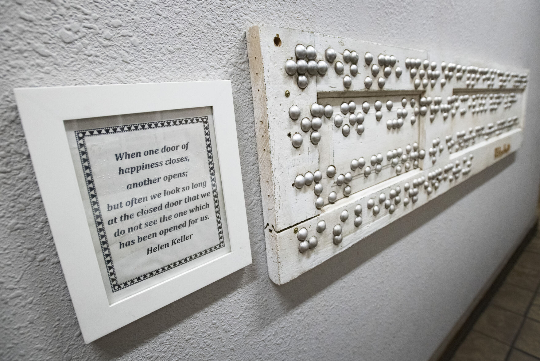 An inspirational quote from Helen Keller written in print and Braille hangs on the wall leading to the restrooms at brewability in Denver. (Christian Murdock,The Gazette)