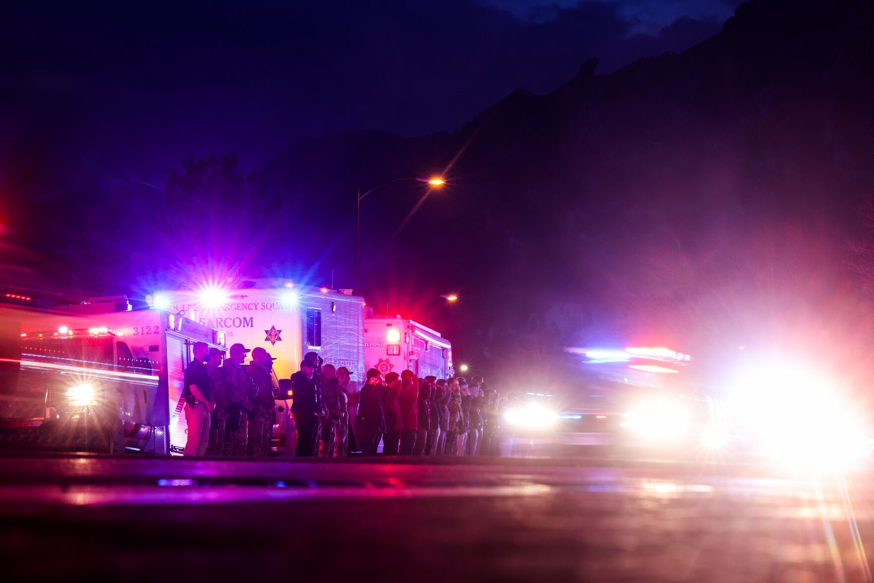 Police officers salute as emergency vehicles escort the body of slain Boulder Police officer Eric Talley from the scene of a shooting at a King Soopers on Monday, March 22, 2021 in Boulder. Ten people were killed in the shooting. (Michael Ciaglo/Special to The Denver Gazette) (Michael Ciaglo/Special to The De)