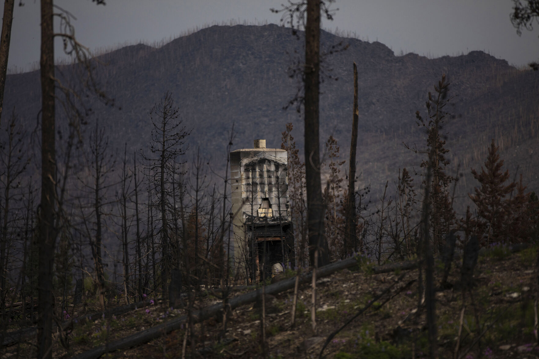 A fireplace remains from a burned home in Grand Lake, Colo., on July 22, 2021. Last October the East Troublesome Fire burned a total of 193,812 acres, becoming the second largest fire in Colorado history. (Chancey Bush/ The Gazette) (Chancey Bush/ The Gazette)