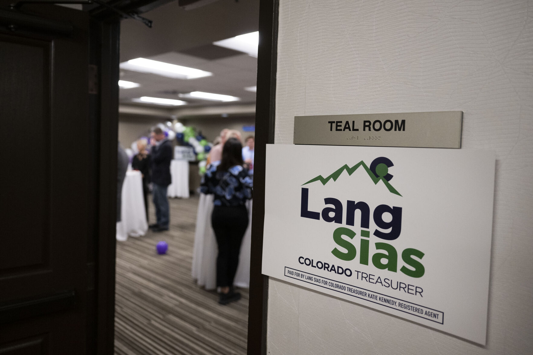 Party-goers hang out in a hotel room for Colorado State Treasurer candidate Lang Sias during the Colorado GOP Election Night Party on Tuesday, Nov. 8, 2022, at the DoubleTree by Hilton DTC in Greenwood Village, Colo. (Timothy Hurst/The Gazette) (TIMOTHY HURST/DENVER GAZETTE)