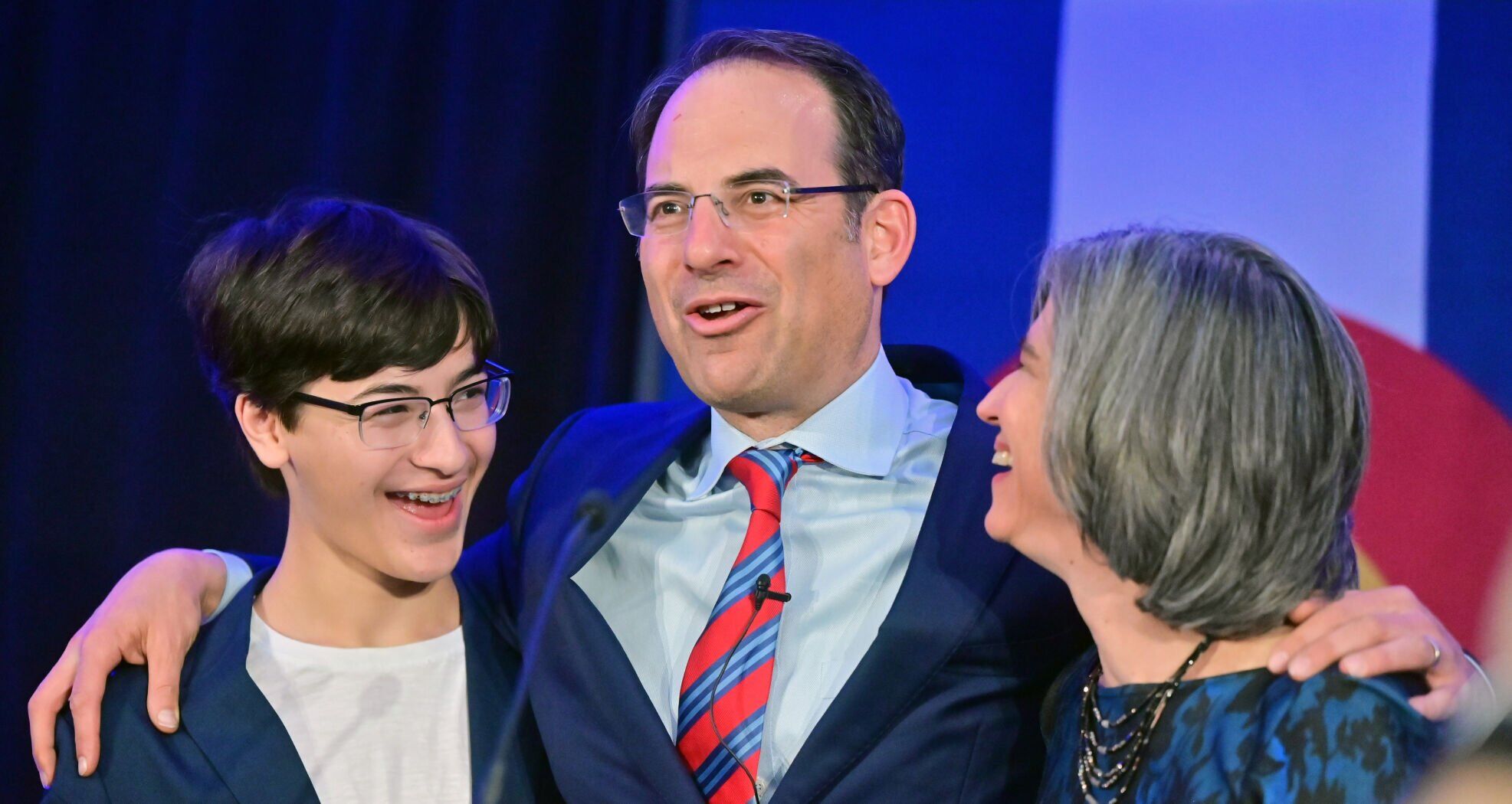 Colorado Attorney Gen. Phil Weiser was flanked by his son, Sammy Weiser, and wife, Heidi Wald, during his victory speech at the Art Hotel on Nov. 8, 2022. (Photo by Jerilee Bennett, The Gazette)