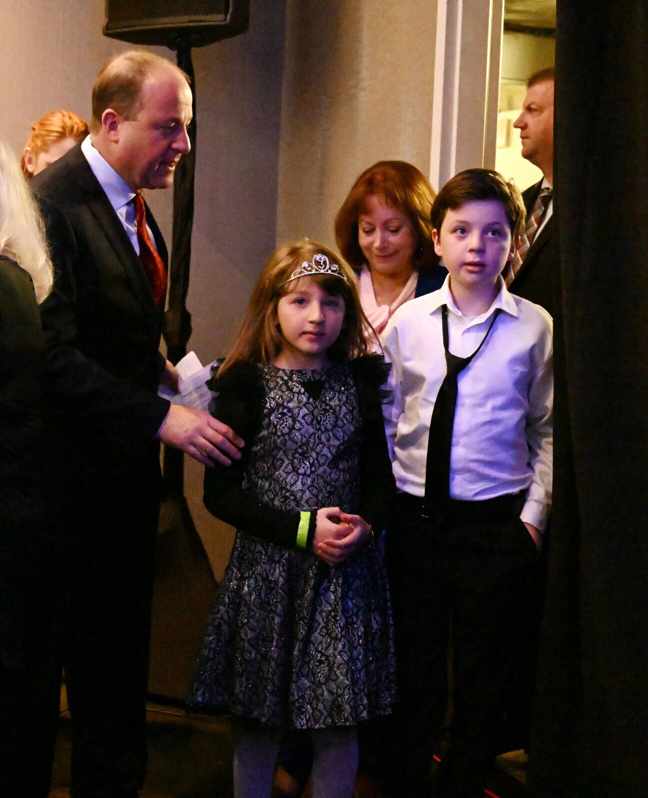 Gov. Jared Polis leads his children, Cora Polis Reis and Caspian Polis Reis, to the stage to give his victory speech after the election on Tuesday, Nov. 8, 2022. (Photo by Jerilee Bennett, The Gazette)