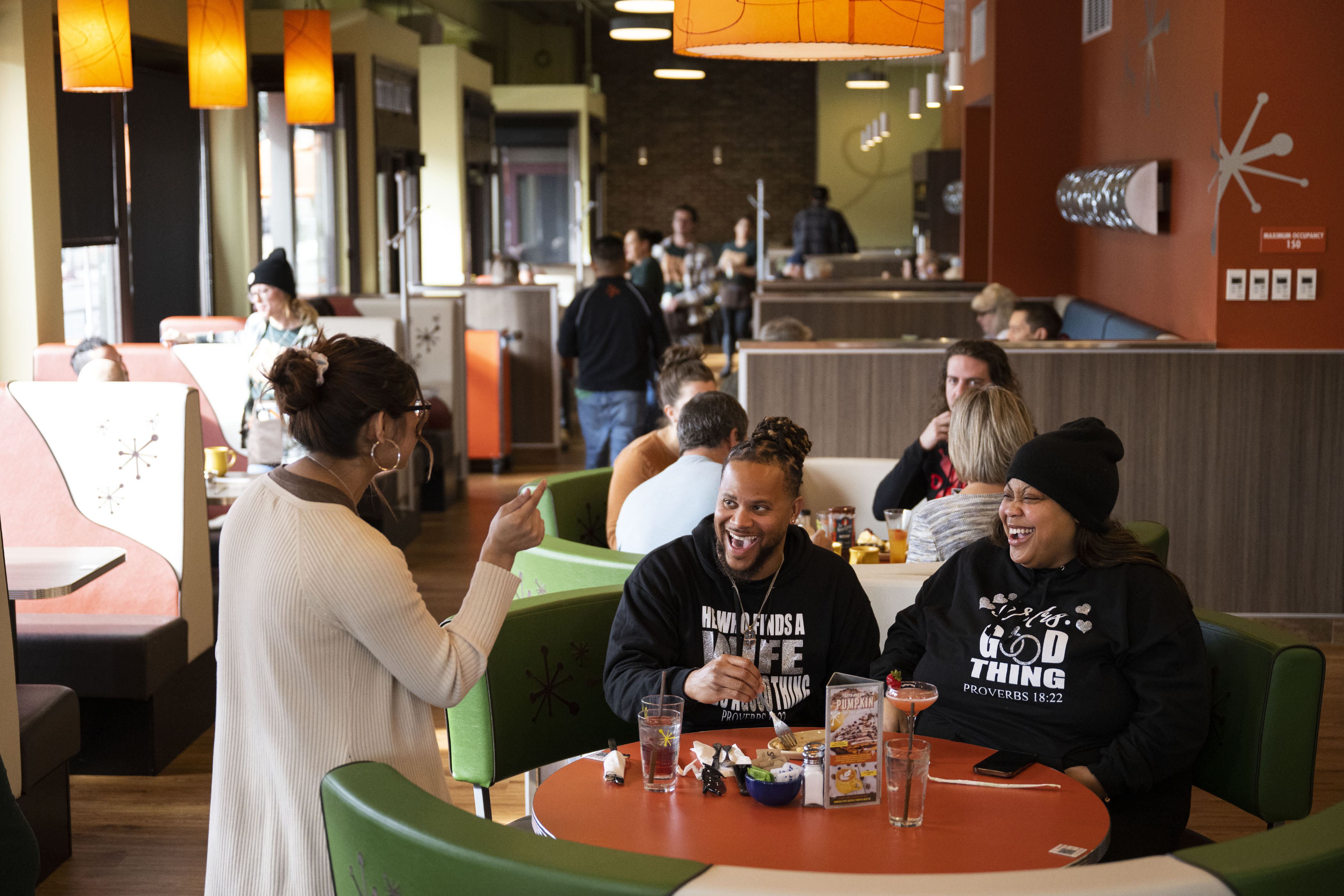 Newlyweds Brandon and Lakeshia Hamilton laugh with their server Cesy Zamarripa while eating their order of upside-down pineapple pancakes at Snooze an A.M. Eatery on Wednesday, Nov. 16, 2022, on North Broadway in Denver. The Hamiltons, from Tennessee, are in Denver for their honeymoon after getting married the previous Saturday. (Timothy Hurst/The Gazette) (TimHursttim.hurst@gazette.comhttps://secure.gravatar.com/avatar/aca82bd62b4ee425c598527cd6faa1b1?d=mm&r=g)