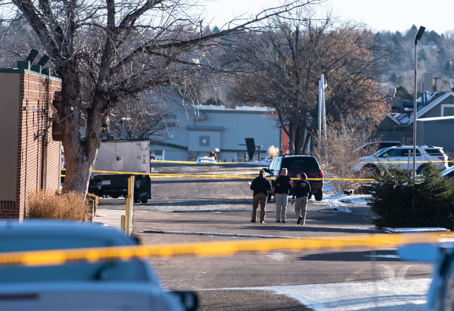 Jace Khosla, right, talks to an officer outside of Club Q where a mass shooting took place late on Saturday, Nov. 19. (The Gazette, Parker Seibold)