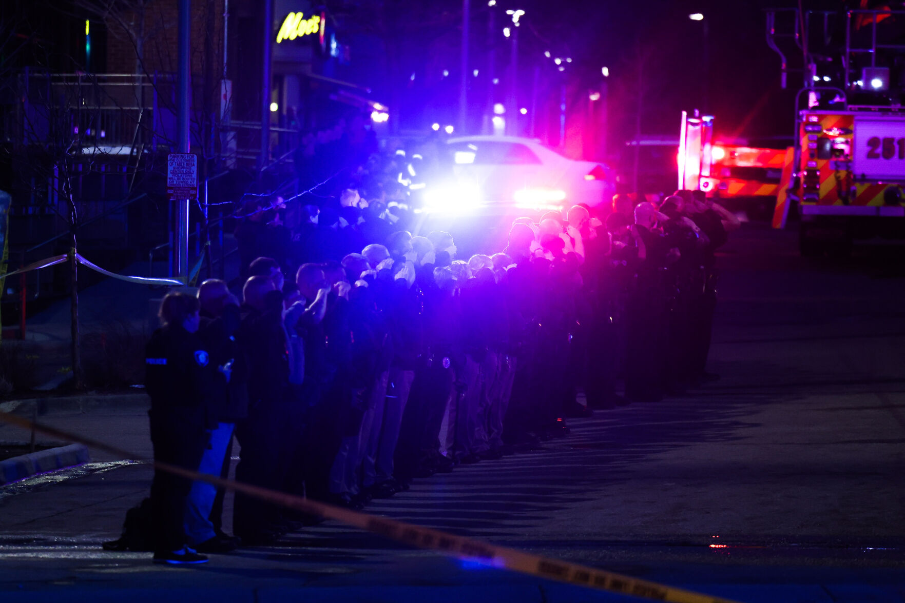 Police officers salute as emergency vehicles prepare to escort the body of slain Boulder Police officer Eric Talley from the scene of a shooting at a King Soopers on Monday, March 22, 2021 in Boulder. Ten people were killed in the shooting. (Michael Ciaglo/Special to The Denver Gazette) (Michael Ciaglo/Special to The De)