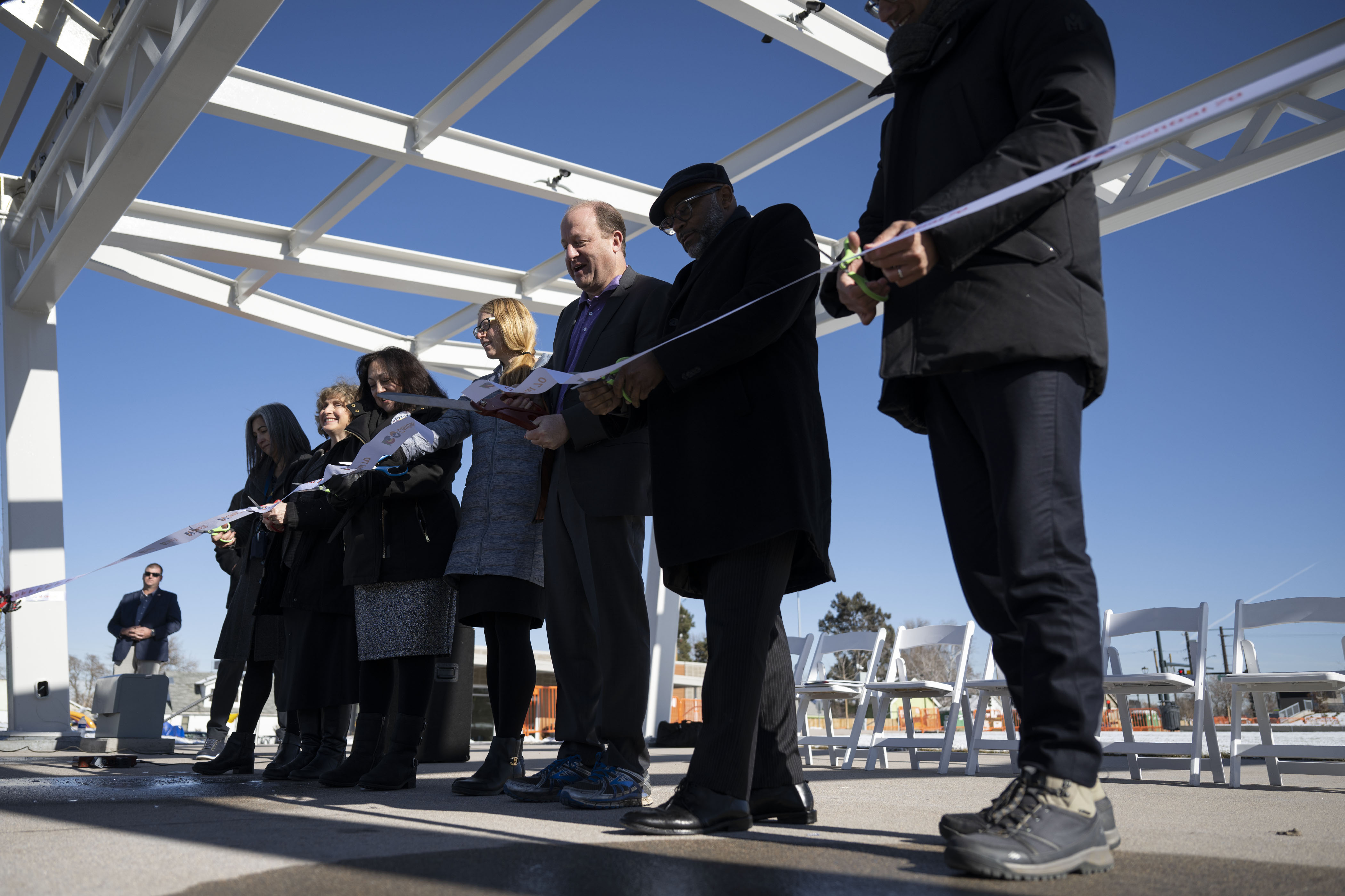 From left, Swansea Elementary School principal Vanessa Trussell, deputy administrator of the Federal Highway Administration Stephanie Pollack, Denver City Council member at-large Debbie Ortega, executive director of the Colorado Department of Transportation Shoshana Lew, Gov. Jared Polis, Denver mayor Michael Hancock and Meridiam chief operating officer Omri Gainsburg cut the ribbon during an event to celebrate the opening of the 4-acre Cover Park over Interstate 70 between Brighton Boulevard and Colorado Boulevard on Wednesday, Nov. 30, 2022, in Denver, Colo. (Timothy Hurst/The Gazette) (TimHursttim.hurst@gazette.comhttps://secure.gravatar.com/avatar/aca82bd62b4ee425c598527cd6faa1b1?d=mm&r=g)