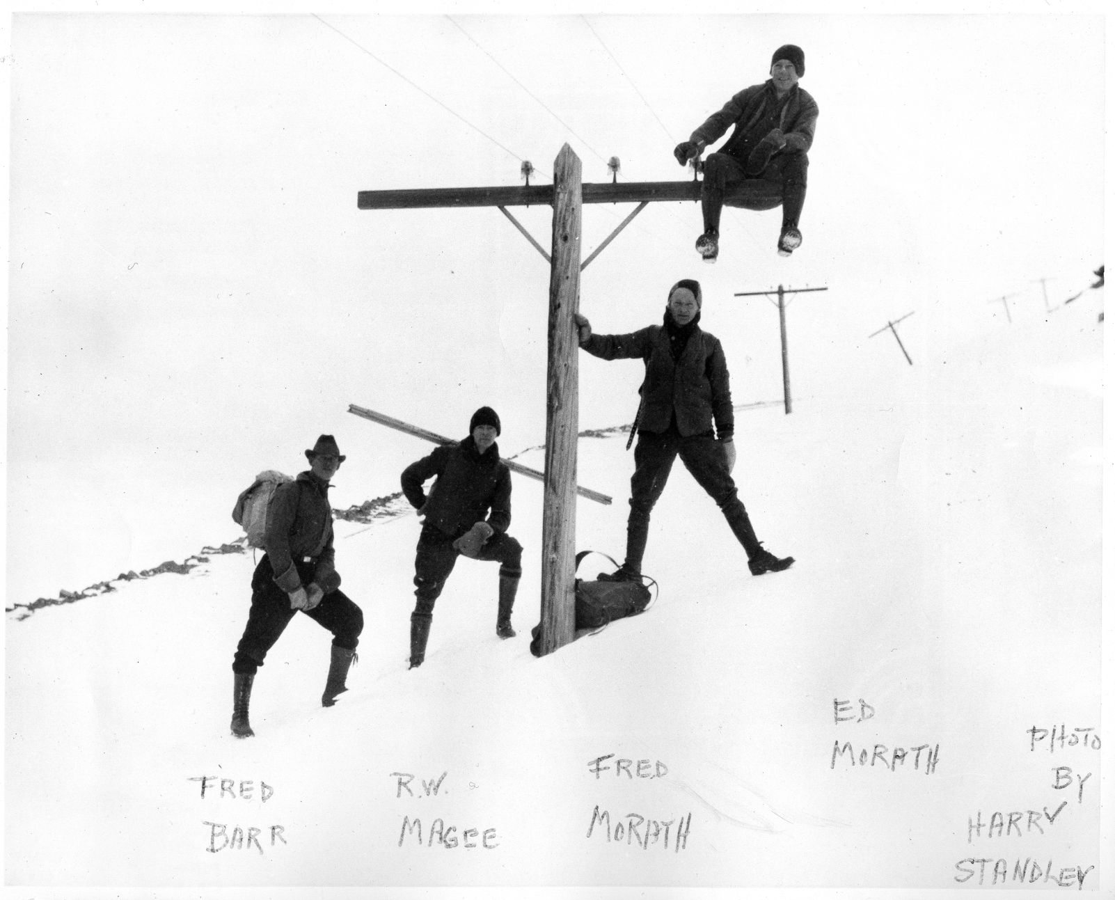The first ascent of the AdAmAn Club on Dec. 31, 1922. Four men, identified on the print as Fred Barr, R.W. Magee, Fred Morath and Ed Morath, pose on and around a telephone pole on Pikes Peak. Harry Standley, also part of the original “Frozen Five,” was the photographer. (PHOTO BY HARRY L. STANDLEY, COURTESY OF PIKES PEAK LIBRARY DISTRICT, 318-2334)