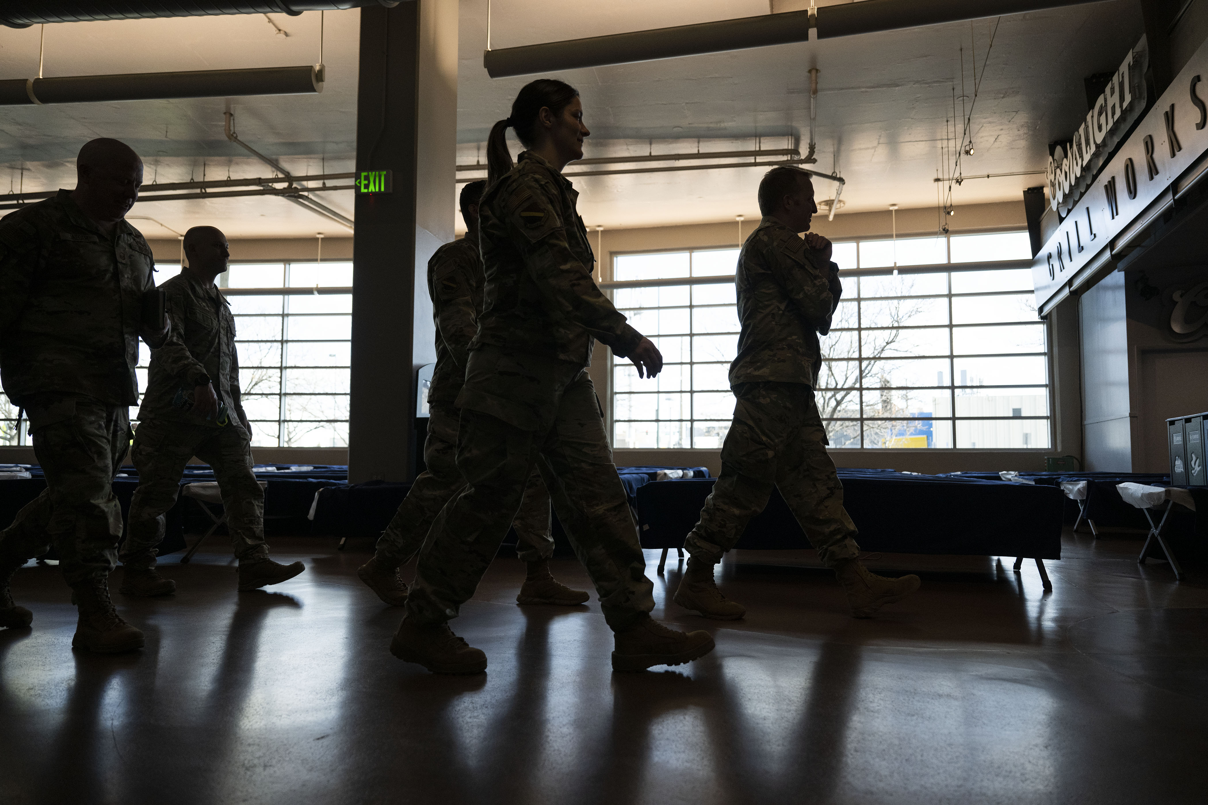 Air National Guard members walk through the hallway of the Denver Coliseum, being opened as a 24-hour emergency warming shelter on Wednesday, Dec. 21, 2022, in Denver, Colo. (Timothy Hurst/The Denver Gazette) (TimHursttim.hurst@gazette.comhttps://secure.gravatar.com/avatar/aca82bd62b4ee425c598527cd6faa1b1?d=mm&r=g)
