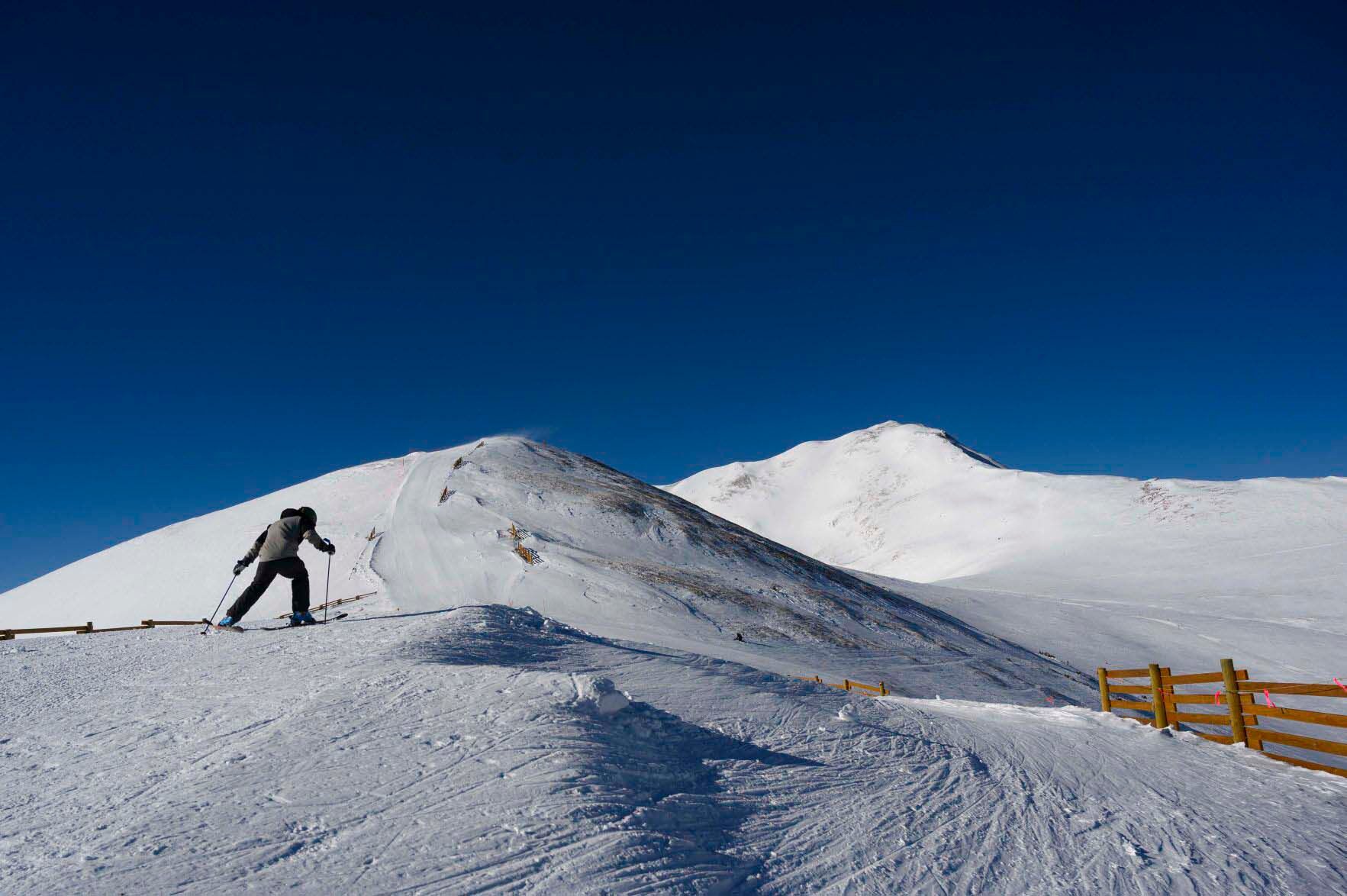 A skier skates along the ridge of 12,421-foot Tucker Mountain before dropping into the double-black run Summit Stash in February 2020, on a sunny day at Copper Mountain resort. (Christian Murdock, Gazette file)