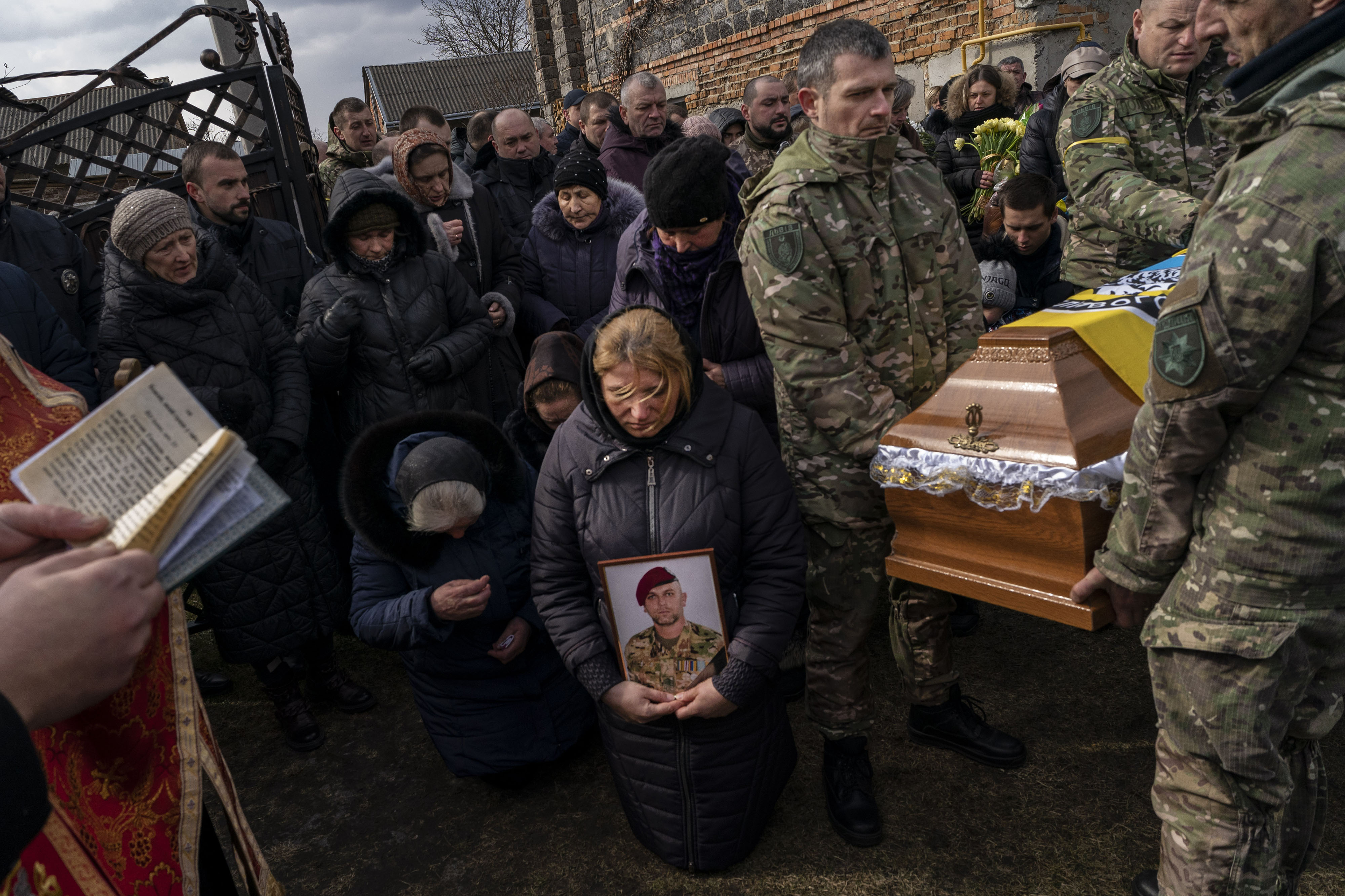 Relatives and friends mourn at the funeral of senior police sergeant Roman Rushchyshyn in the village of Soposhyn, outskirts of Lviv, western Ukraine, Thursday, March 10, 2022, in Lviv. Rushchyshyn, a member of the Lviv Special Police Patrol Battalion, was killed in the Luhansk Region. (AP Photo/Bernat Armangue) (Bernat Armangue)