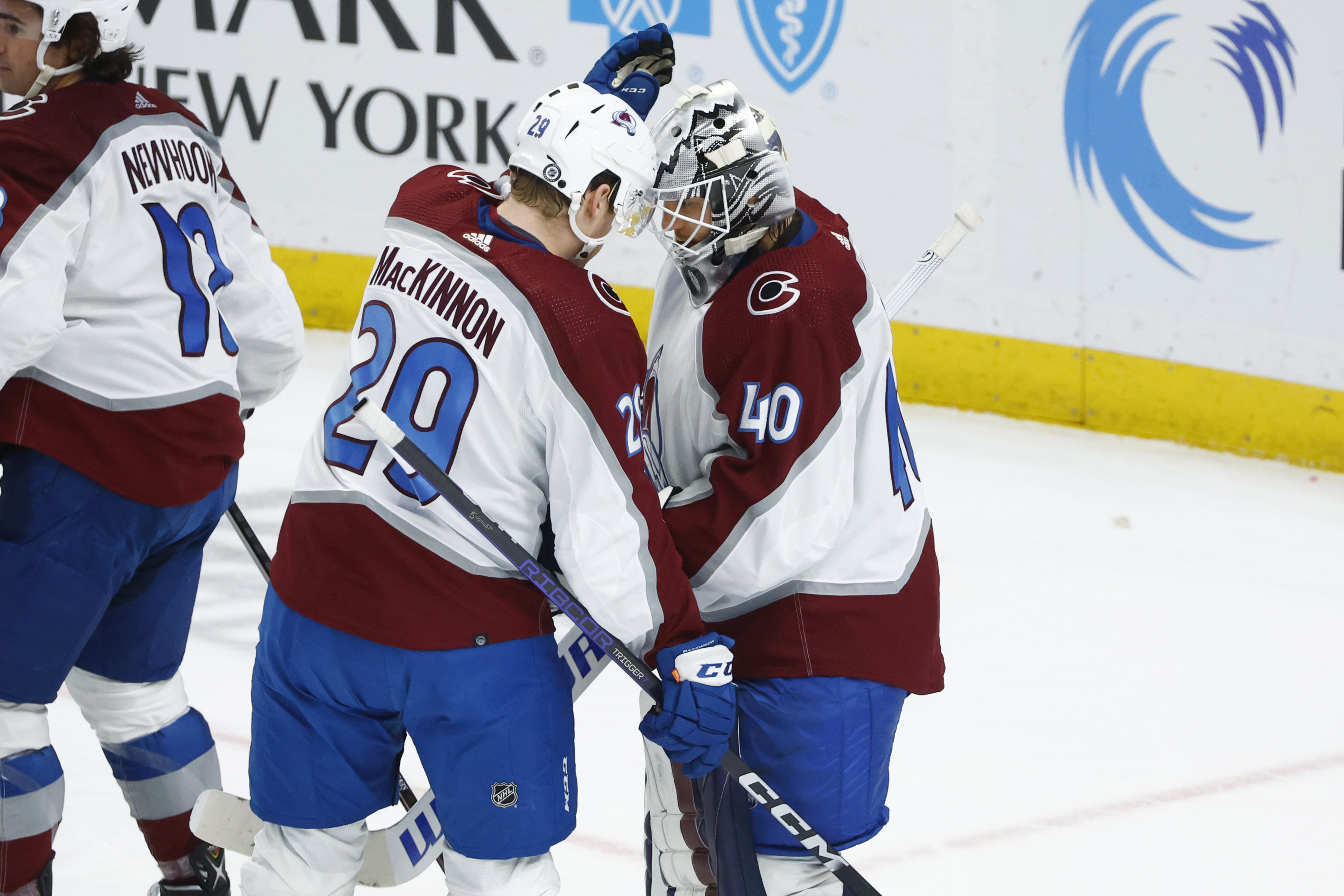 Colorado Avalanche center Nathan MacKinnon (29) and goaltender Alexandar Georgiev (40) celebrate a victory over the Buffalo Sabres in an NHL hockey game, Thursday, Dec. 1, 2022, in Buffalo, N.Y. (AP Photo/Jeffrey T. Barnes) (Jeffrey T. Barnes)