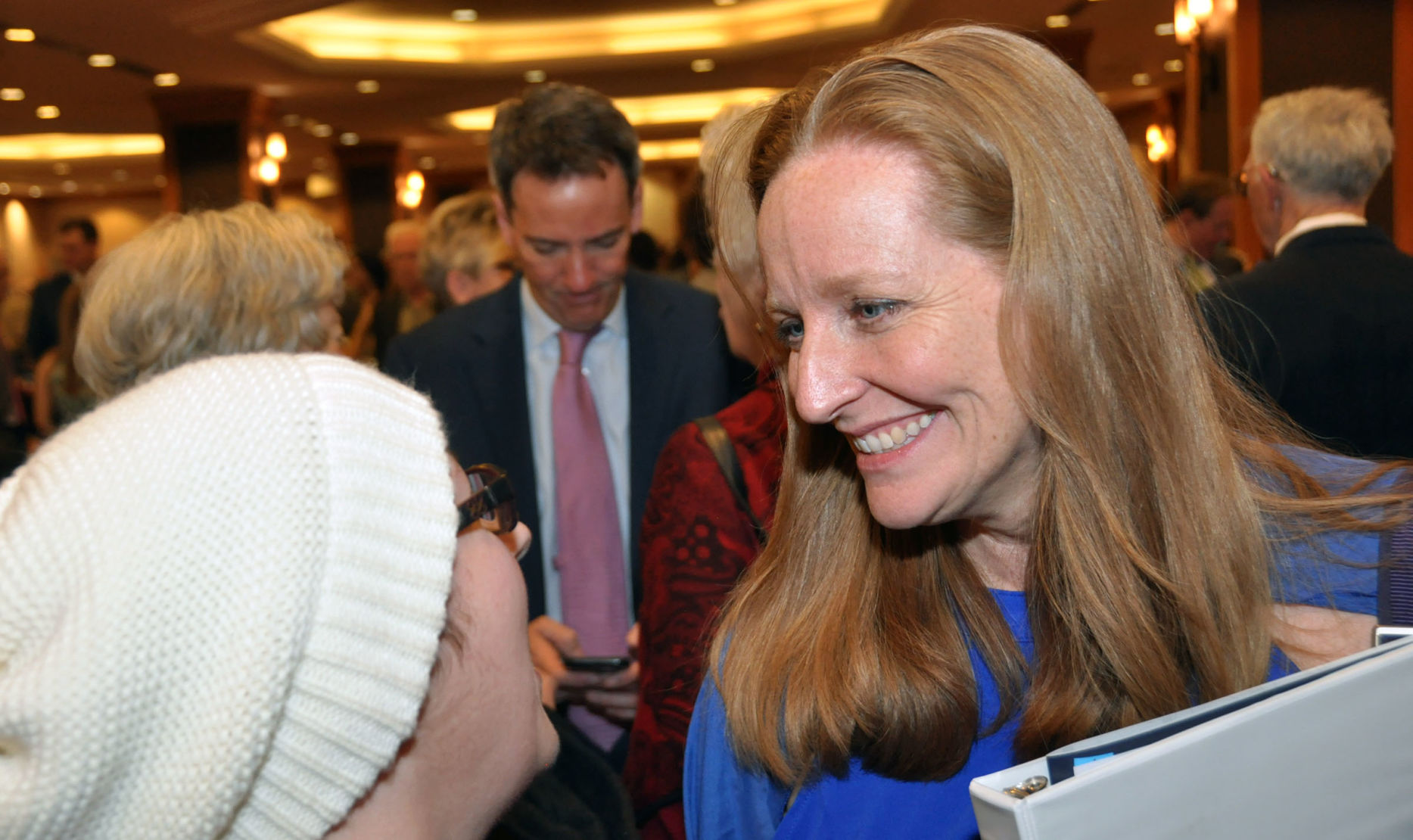 In this file photo, Colorado Democratic Party Chair Morgan Carroll, right, visits with Democrats at the party's Obama Dinner fundraiser on Saturday, March 9, 2019, at the Sheraton Denver Downtown Hotel. Earlier in the day, Carroll was elected to a second, two-year term heading the party. ((Ernest Luning/Colorado Politics))