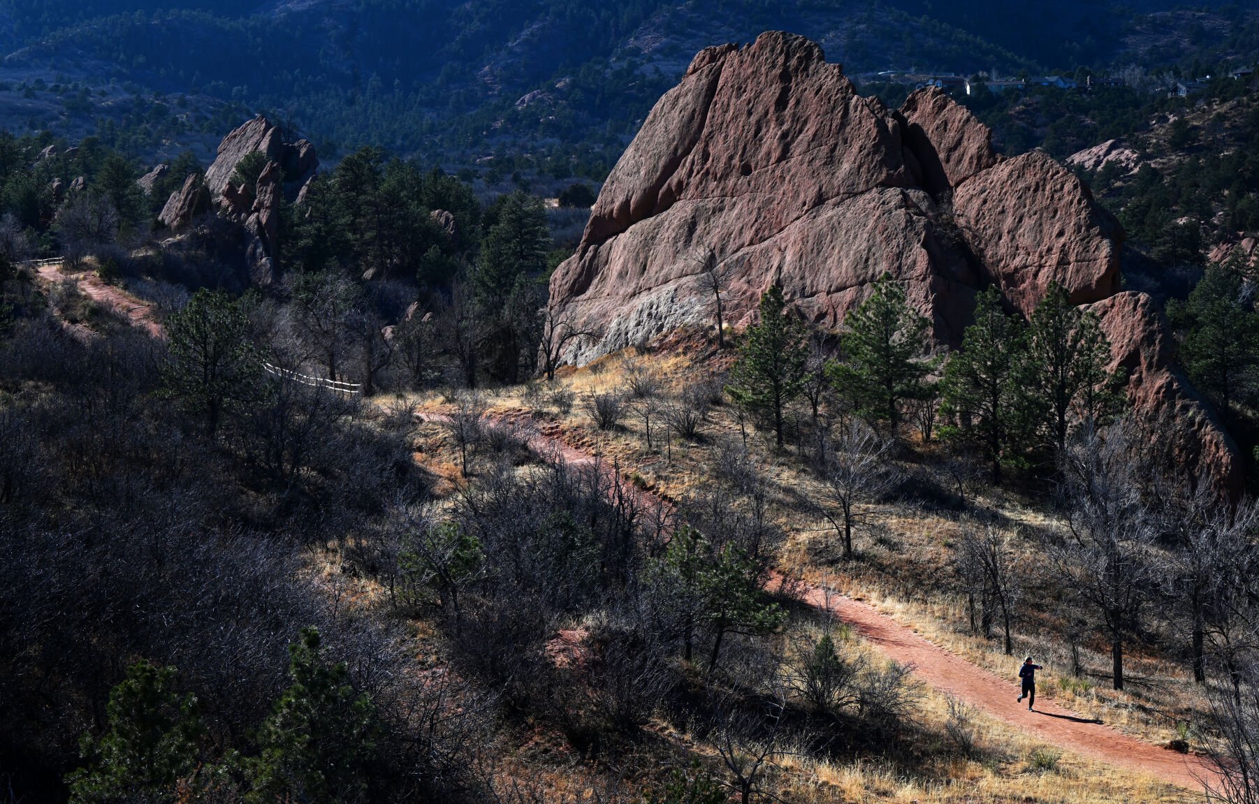A runner jogs along the Sand Canyon Trail in Red Rock Canyon Open Space Friday. The popular park in Colorado Springs was slated to become a resort community with a convention center and private golf course before it was purchased in 2003 by the city with Trails, Open Space and Parks tax revenue. (Christian Murdock, The Gazette)
