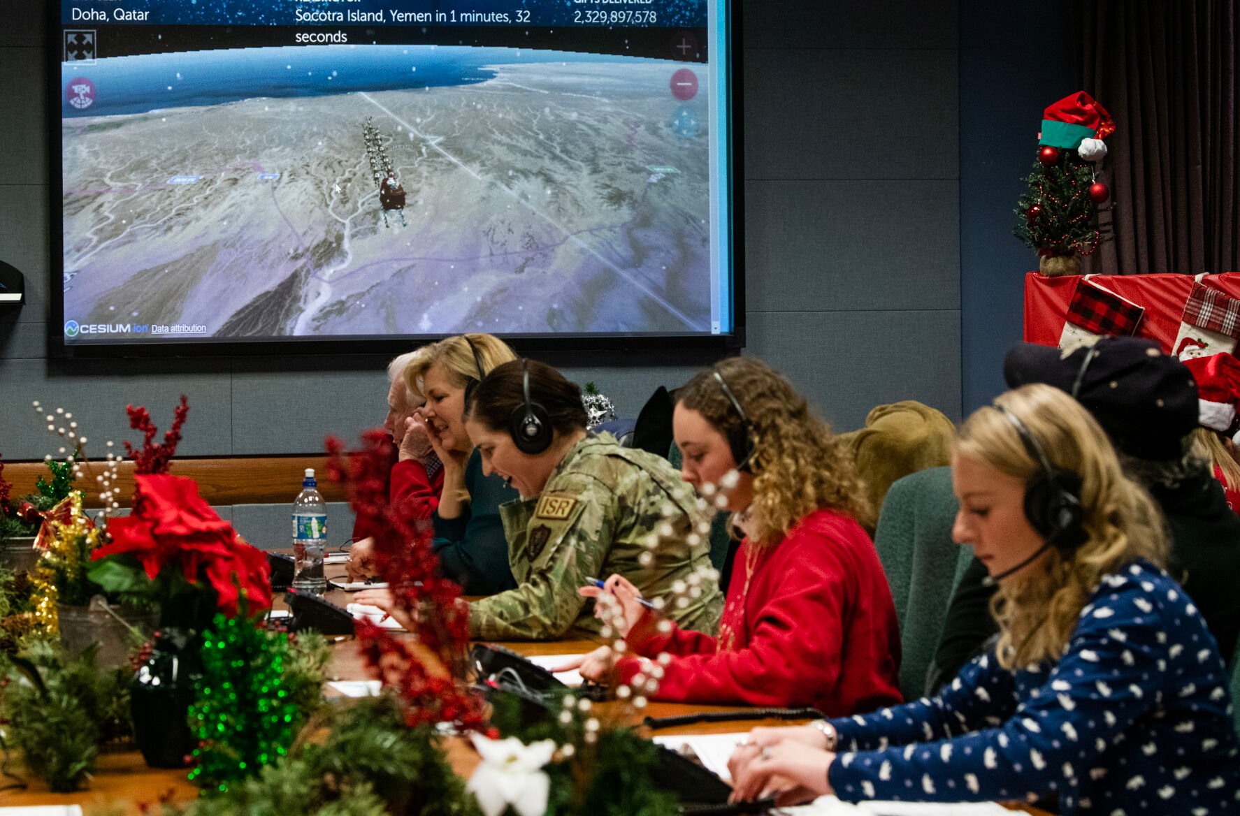 Volunteers work as Santa trackers at the NORAD Tracking Center, answering calls from all over the world to tell children the whereabouts of Santa. Santa tracking started back in 1955, when a young boy dialed a misprinted number from an advertisement and got Continental Defense Air Command on the phone. After the boy was assured that Santa would make it home safely, a tradition was born. (The Gazette, Parker Seibold) (Parker Seibold)