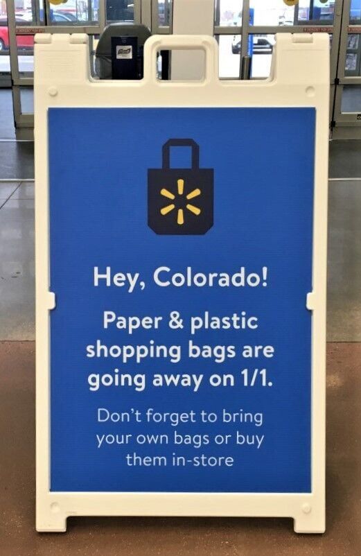 Retail giant Walmart has been warning shoppers for weeks it no longer will provide plastic and paper bags beginning Sunday, in keeping with a new state law that bans plastic bags. Walmart and other retailers are urging shoppers to bring reusable bags with them on their shopping trips. (RICH LADEN, </p><p>pikes peak courier)” /><figcaption class=