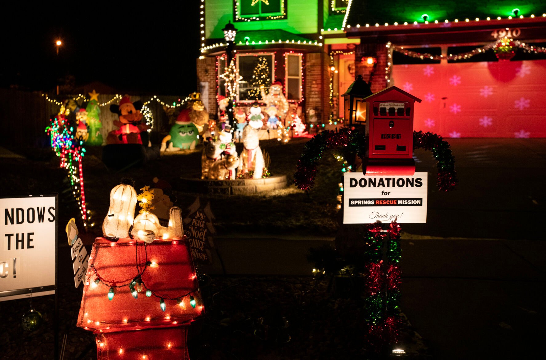 On one side of Mark Ingles’ driveway is a red mailbox set up to collect donations for Springs Rescue Mission and on the other is a large chest freezer for donations of nonperishable food items for Care and Share Food Bank. (Parker Seibold)