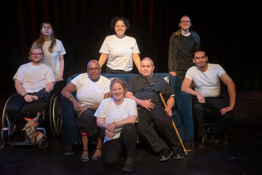 Visual description: A portrait shot of the cast of Phamaly Theatre Company's 'Vox Vergere,' most wearing white tops, looking at the camera. The eight actors are, in alphabetical order, Nicole Bailey, Samantha Barrasso, Apollo Blue, Shannon Brennan, Paul Migliorelli, Cipriano Ortega, Laurice Quinn and Ratt Walsh. (MICHAEL ENSMINGER/PHAMALY)