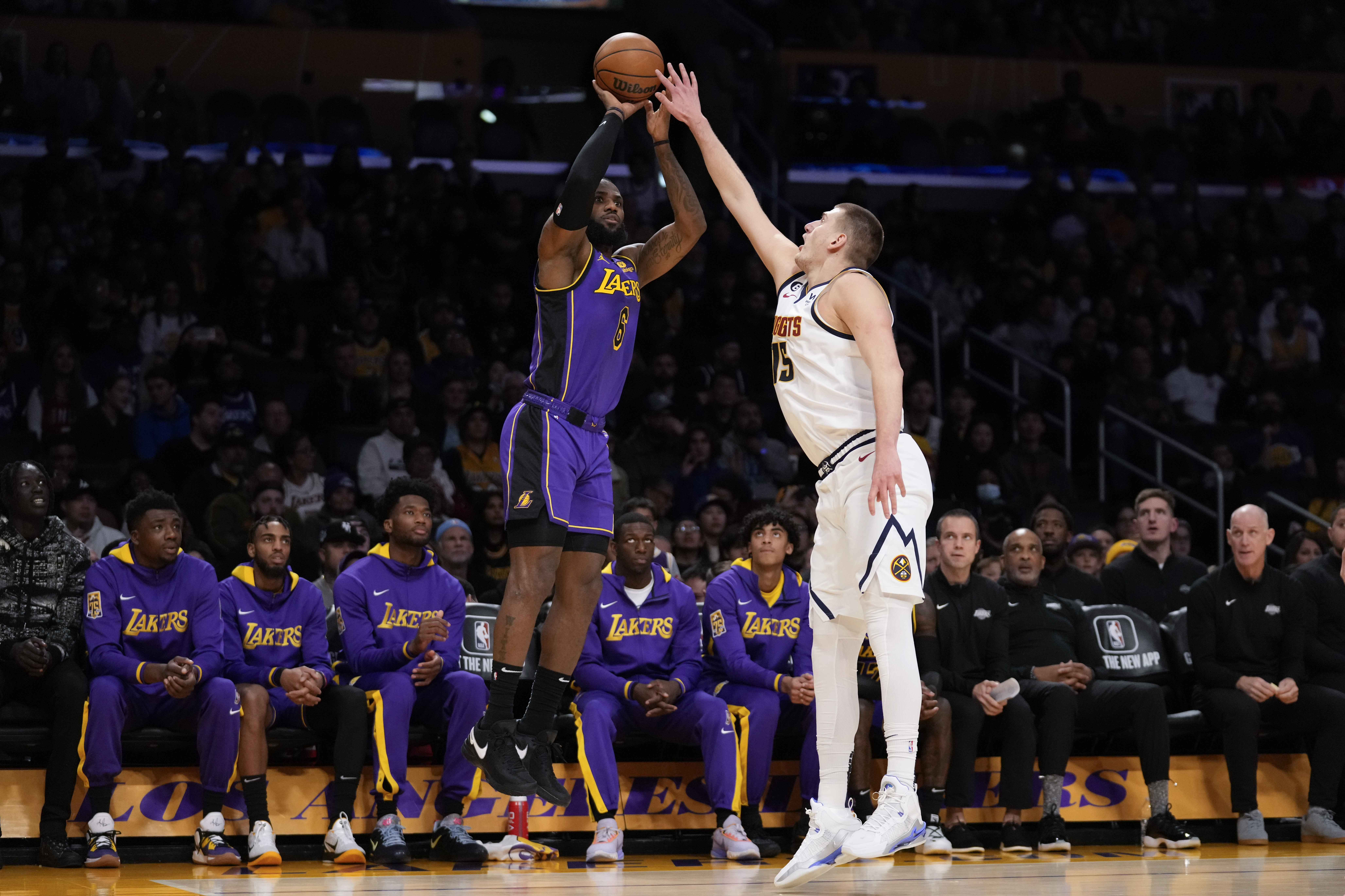 Los Angeles Lakers forward LeBron James (6) shoots against Denver Nuggets center Nikola Jokic (15) during the first half of an NBA basketball game in Los Angeles, Friday, Dec. 16, 2022. (AP Photo/Ashley Landis) (Ashley Landis)