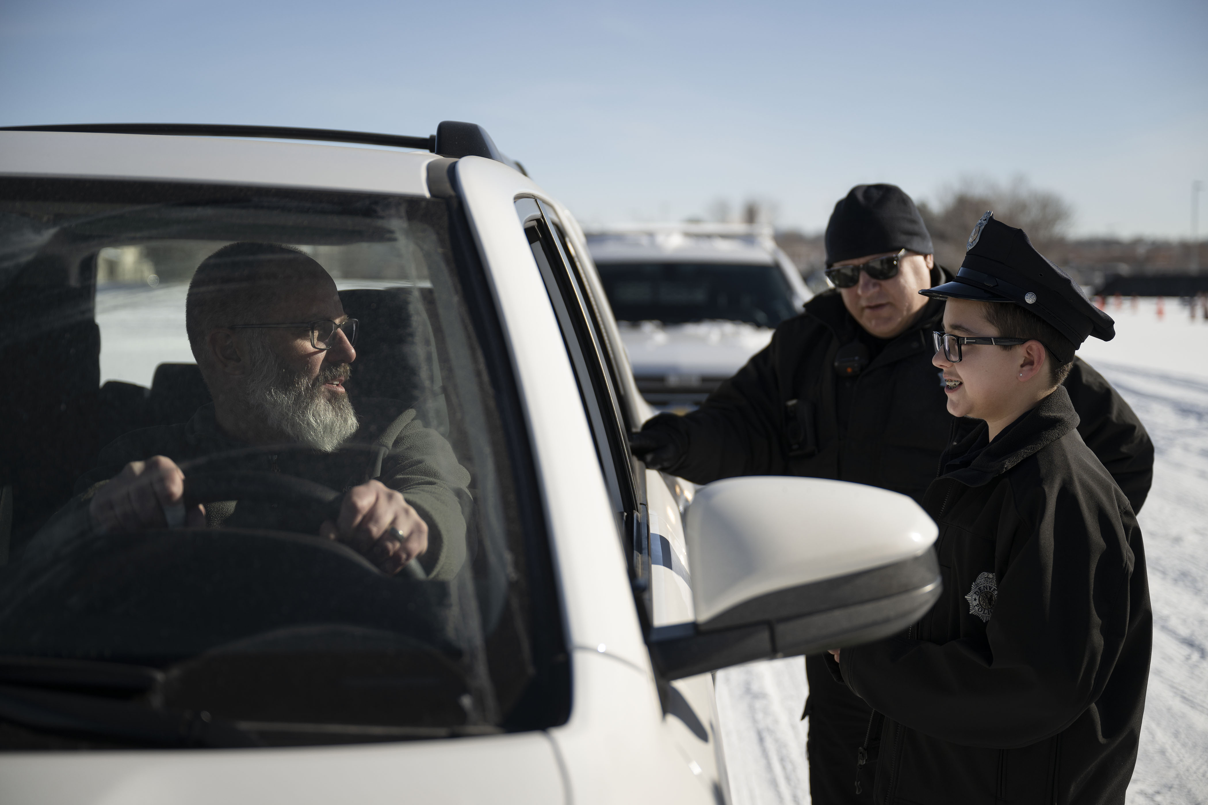 Kamorin, 14, no last name given, and his partner for the day, officer David Briggs, talk to outreach case coordinator Matt Trenery before giving him a ticket during a simulated ride along on Friday, Dec. 23, at the Denver Police Academy in Denver, Colo. On August 22, 2022, Kamorin was being driven home from school when a bullet fired nearby hit him in the arm. Denver police arrived and performed initial first aid. (Timothy Hurst/The Denver Gazette) (TimHursttim.hurst@gazette.comhttps://secure.gravatar.com/avatar/aca82bd62b4ee425c598527cd6faa1b1?d=mm&r=g)