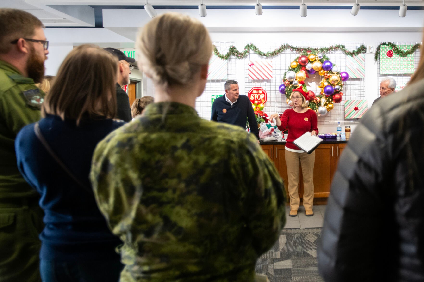 Jennifer Schaming-Ronan center, gives instructions to volunteers before they start their shifts as Santa trackers on Christmas Eve. (The Gazette, Parker Seibold) (Parker Seibold)