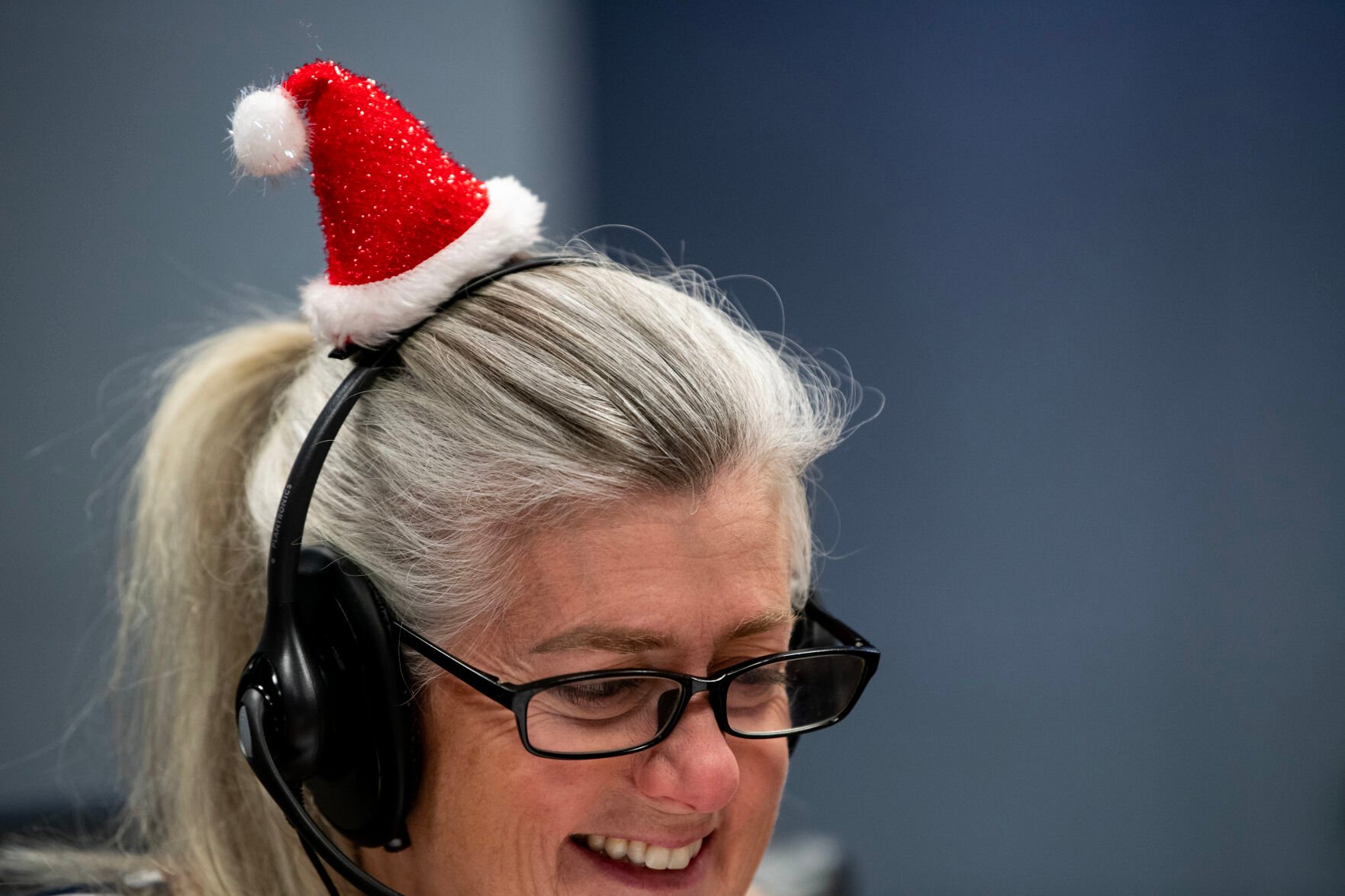Elizabeth Baldwin-Jones speaks to a caller at the NORAD Tracks Santa Operations Center on Christmas Eve. Each year, volunteers work in two hour shifts on Christmas Eve to answer as many as 60,000 calls about Santa’s whereabouts. (The Gazette, Parker Seibold) (Parker Seibold)