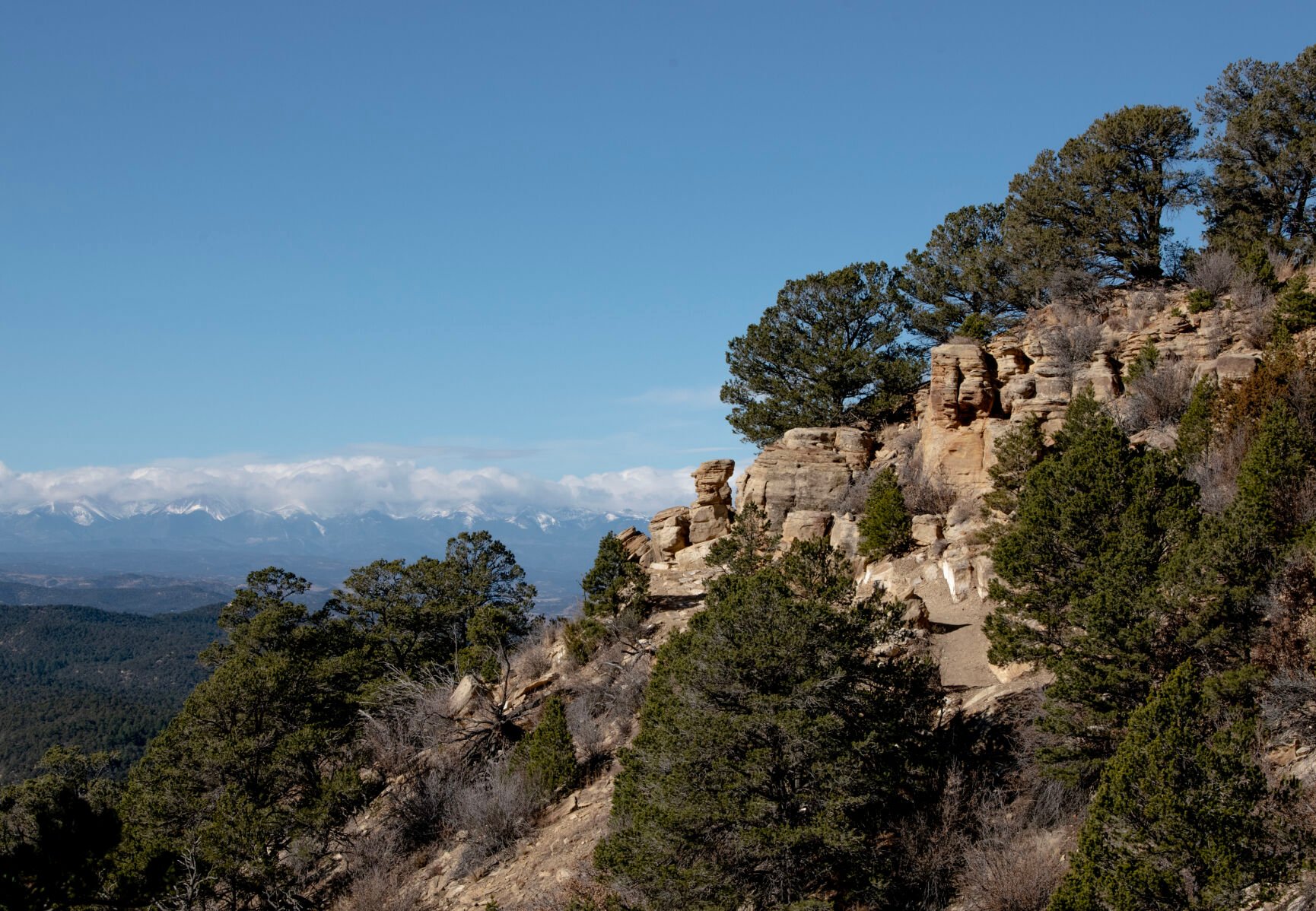 Snowcapped peaks are seen beyond sandstone bluffs at Fishers Peak State Park in Trinidad, Colo., on Tuesday, Dec. 6, 2022. (The Gazette, Parker Seibold) (Parker Seibold)