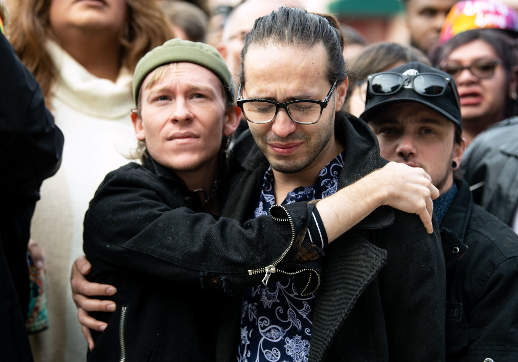 Wyatt Kent, left, the partner of Daniel Aston, one of the victims of the shooting at Club Q, and Autumn Quinn, right, embrace at a 