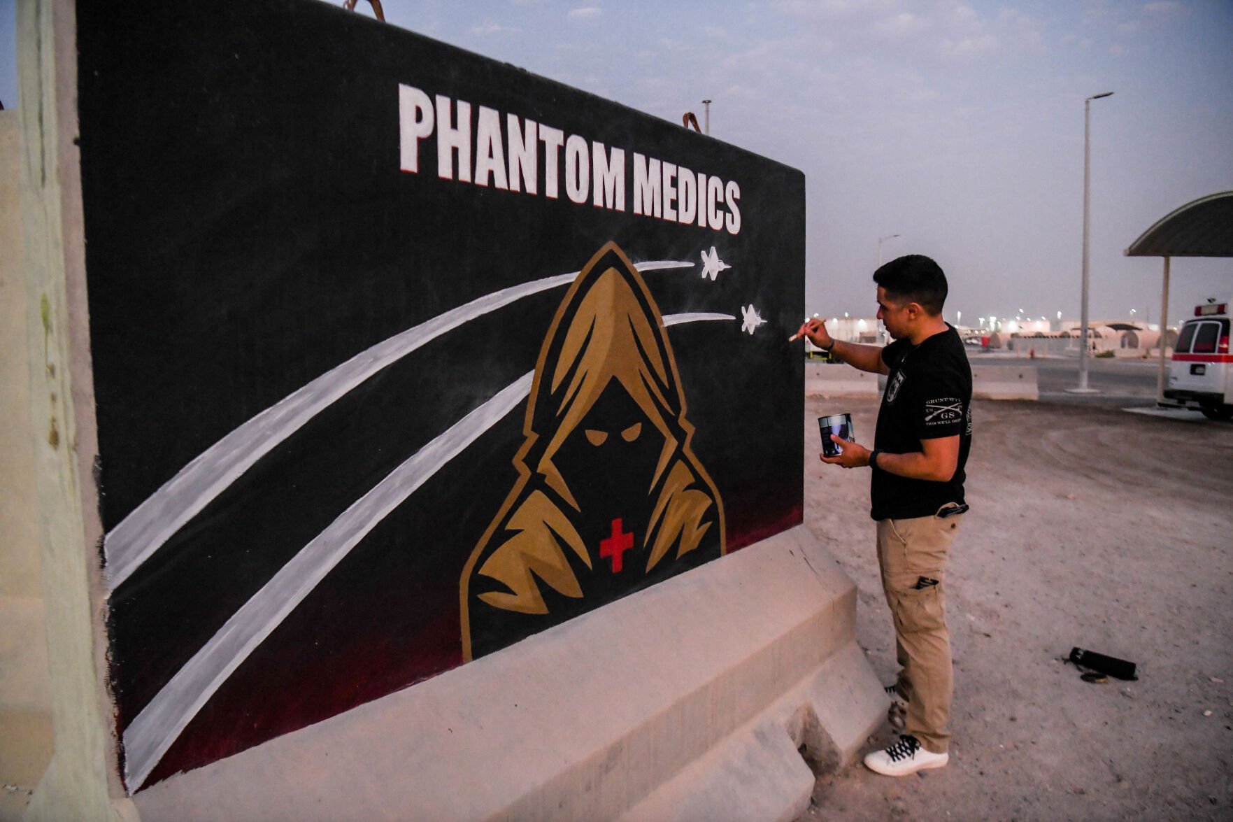 Army Sgt. Anthony Castillo touches up a mural he painted for the 380th Expeditionary Medical Squadron at Al Dhafra Air Base, United Arab Emirates, in September. (Tech. Sgt. Jeffrey Grossi)