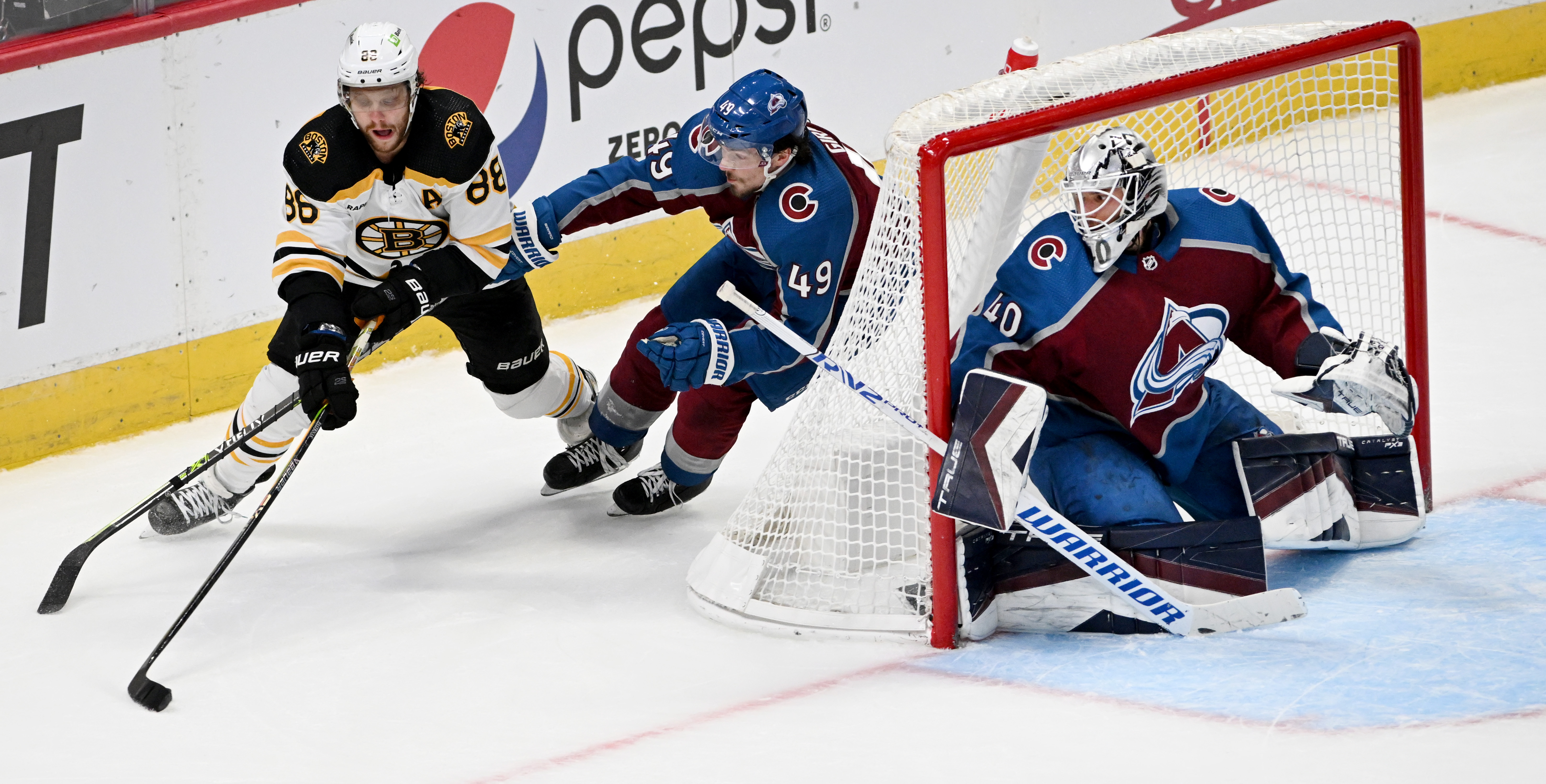 Boston Bruins right wing David Pastrnak (88) takes a shot on goal as Colorado Avalanche defenseman Samuel Girard (49) and goaltender Alexandar Georgiev (40) defend during the second period Wednesday, Dec. 7, 2022, at Ball Arena in Denver. (The Gazette, Christian Murdock) (Christian Murdock/The Gazette)