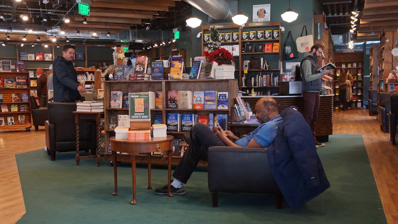 Elaric Gathings sits in one of the many chairs in the Tattered Cover Bookstores. (Alex Edwards, The Denver Gazette)
