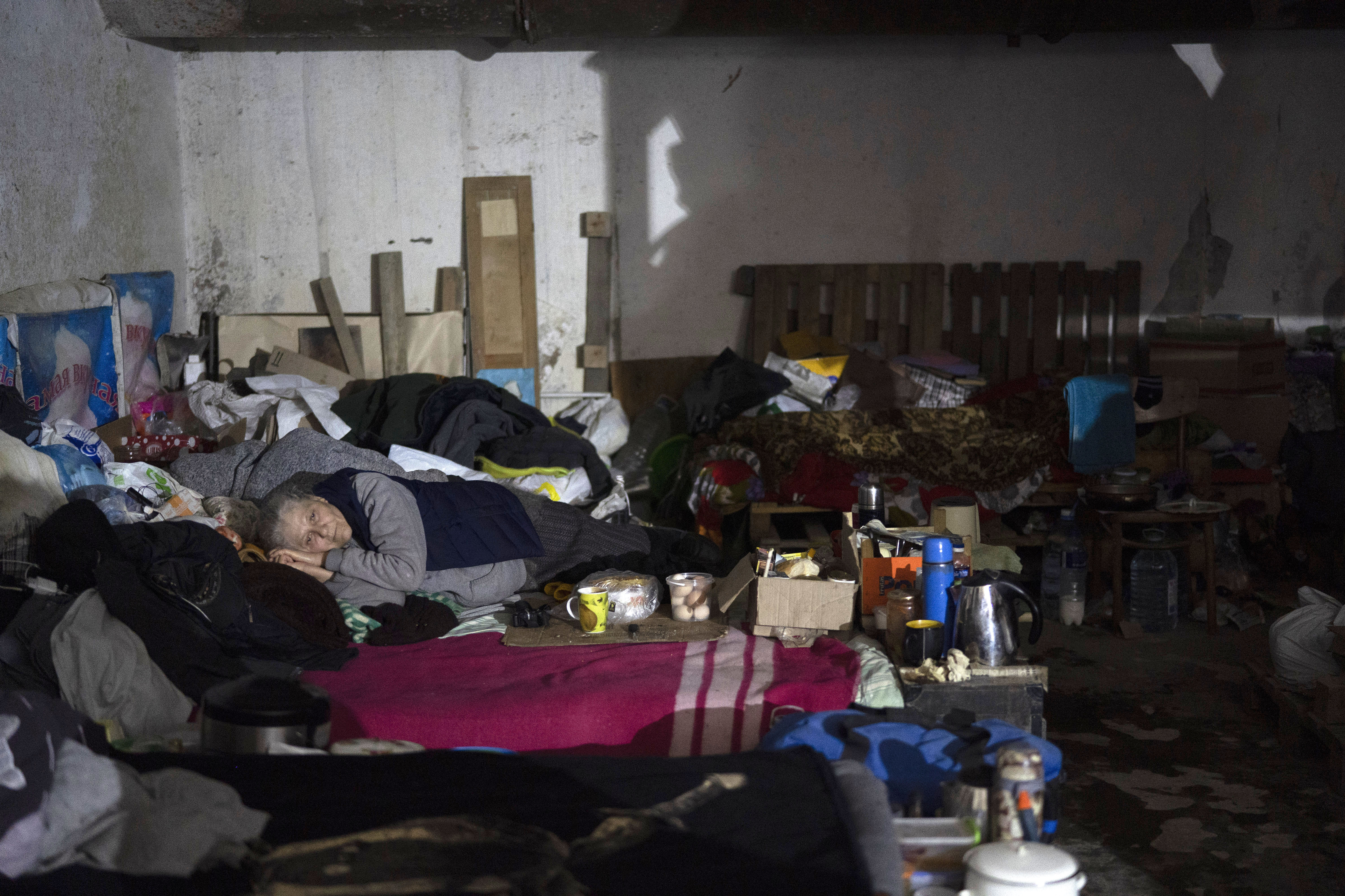 A woman lies on a bed inside a basement used as a bomb shelter during Russian attacks in Severodonetsk, Luhansk region, Ukraine, Friday, May 13, 2022. (AP Photo/Leo Correa) (LEO CORREA/ASSOCIATED PRESS)