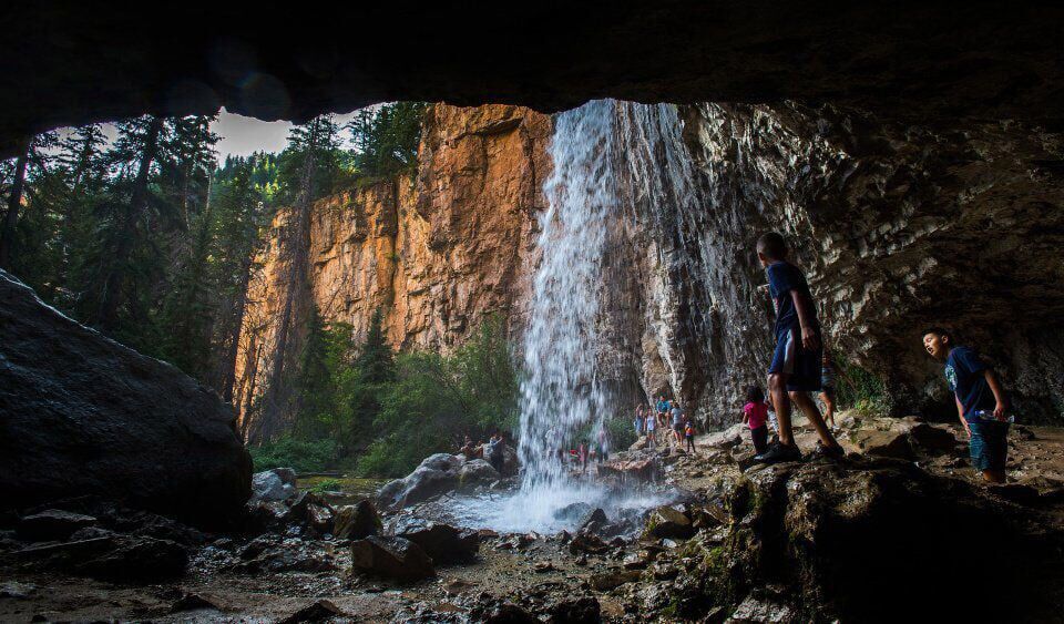 Hikers play in the falls at Spouting Rock above Hanging Lake in Glenwood Canyon. (Christian Murdock, The Gazette)