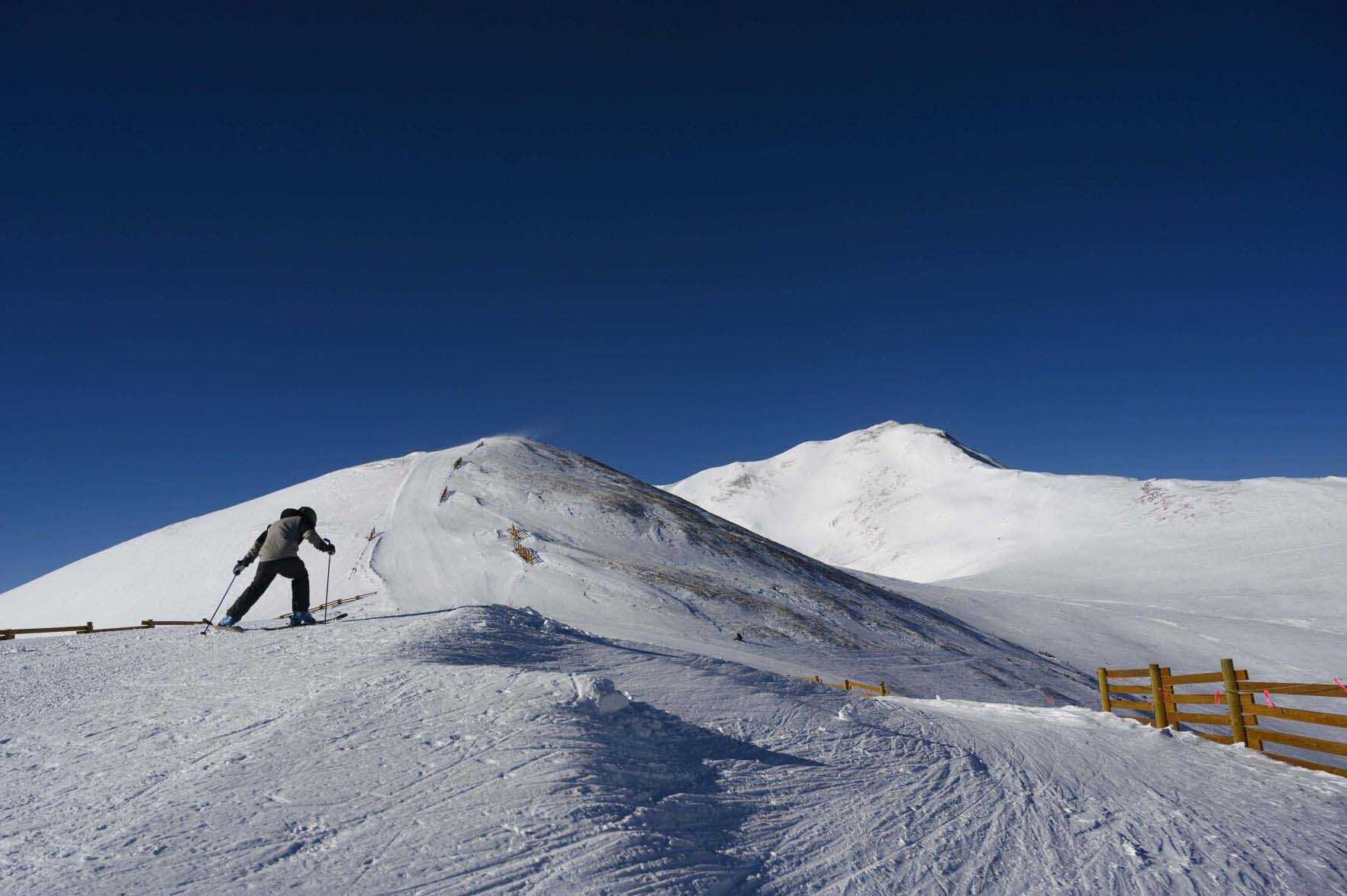 A skier skates along the ridge of 12,421-foot Tucker Mountain before dropping into the double-black run Summit Stash in February 2020, on a sunny day at Copper Mountain resort. (Christian Murdock, Gazette file)