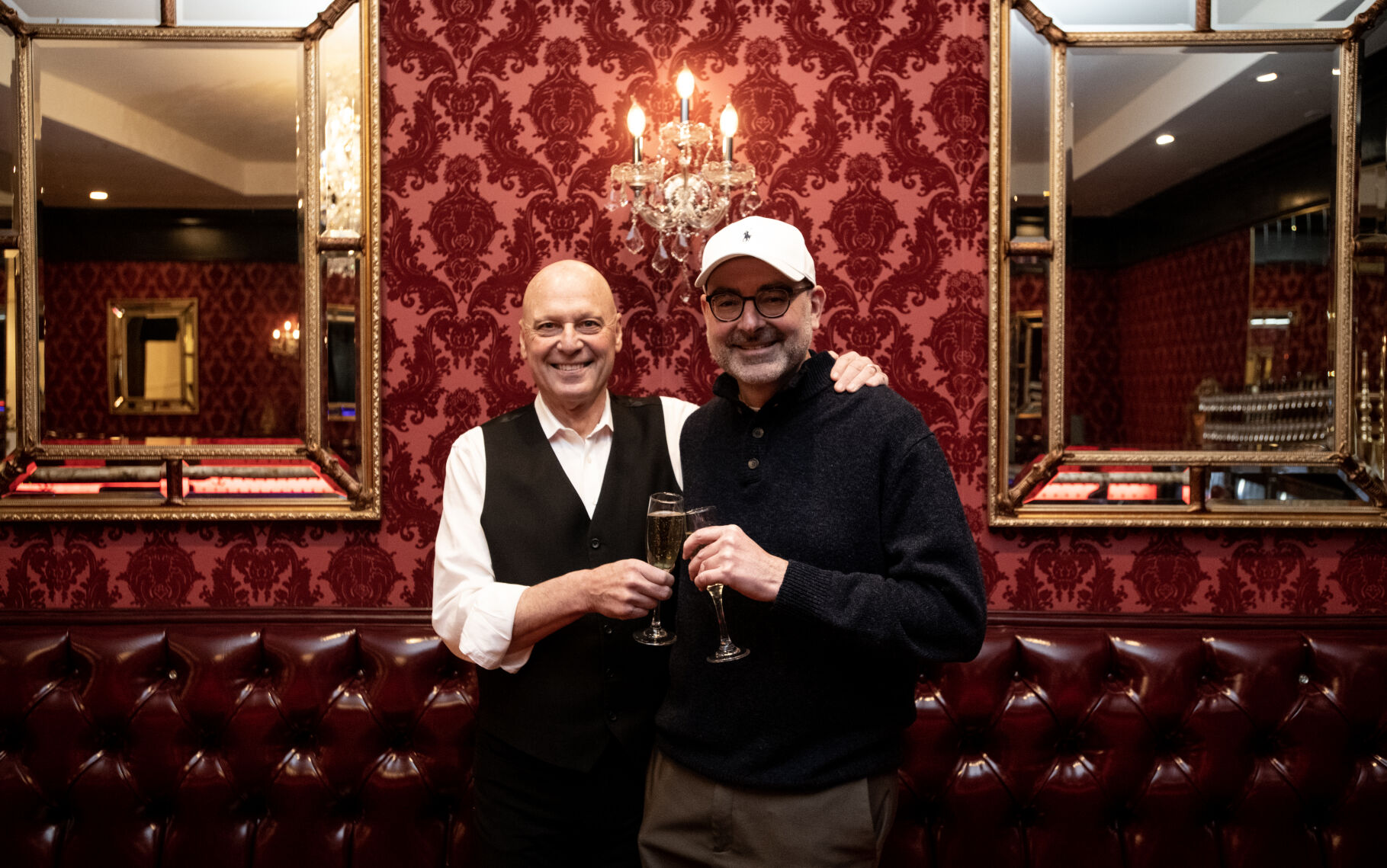 The Antlers Hotel owners Perry Sanders Jr., left, and John Goede toast with Champagne in the hotel’s lobby bar on Friday. The pair are celebrating seven years of joint ownership of the hotel, which they bought in the fall of 2015. In honor of the seven years, a seven-hour, seven-day-a-week happy hour special will be offered at the hotel's Duca's Neapolitan Pizza and The Antlers' lobby bar. (The Gazette, Parker Seibold) (Parker Seibold)