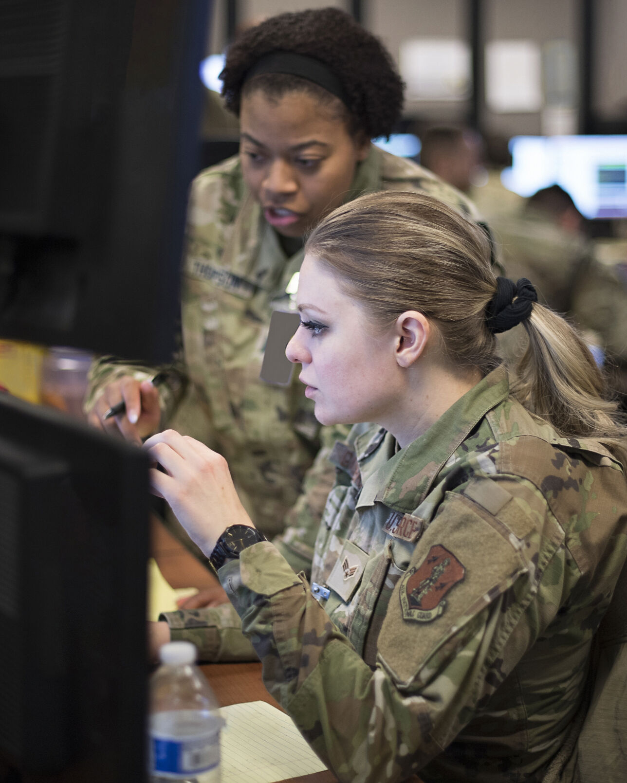 U.S. Space Force Capt. Eries Thompson, back, from the 4th Space Operations Squadron works with Senior Airman Melissa Garverick from the 148th Space Operations Squadron to ensure the free flow of simulated military satellite communications to U.S. European Command in December.Eries_Thompson.jpg (Courtesy of U.S. Space Force)