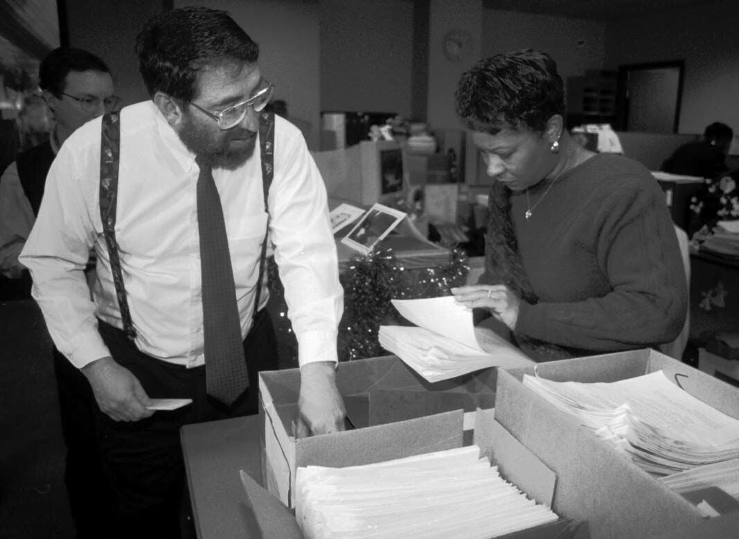 Lee Milner talks with City Clerk Kathryn Young after dropping off over 11,000 signatures on petitions for a trails and open space ballot initiative on Dec. 23, 1996. (The gazette file)