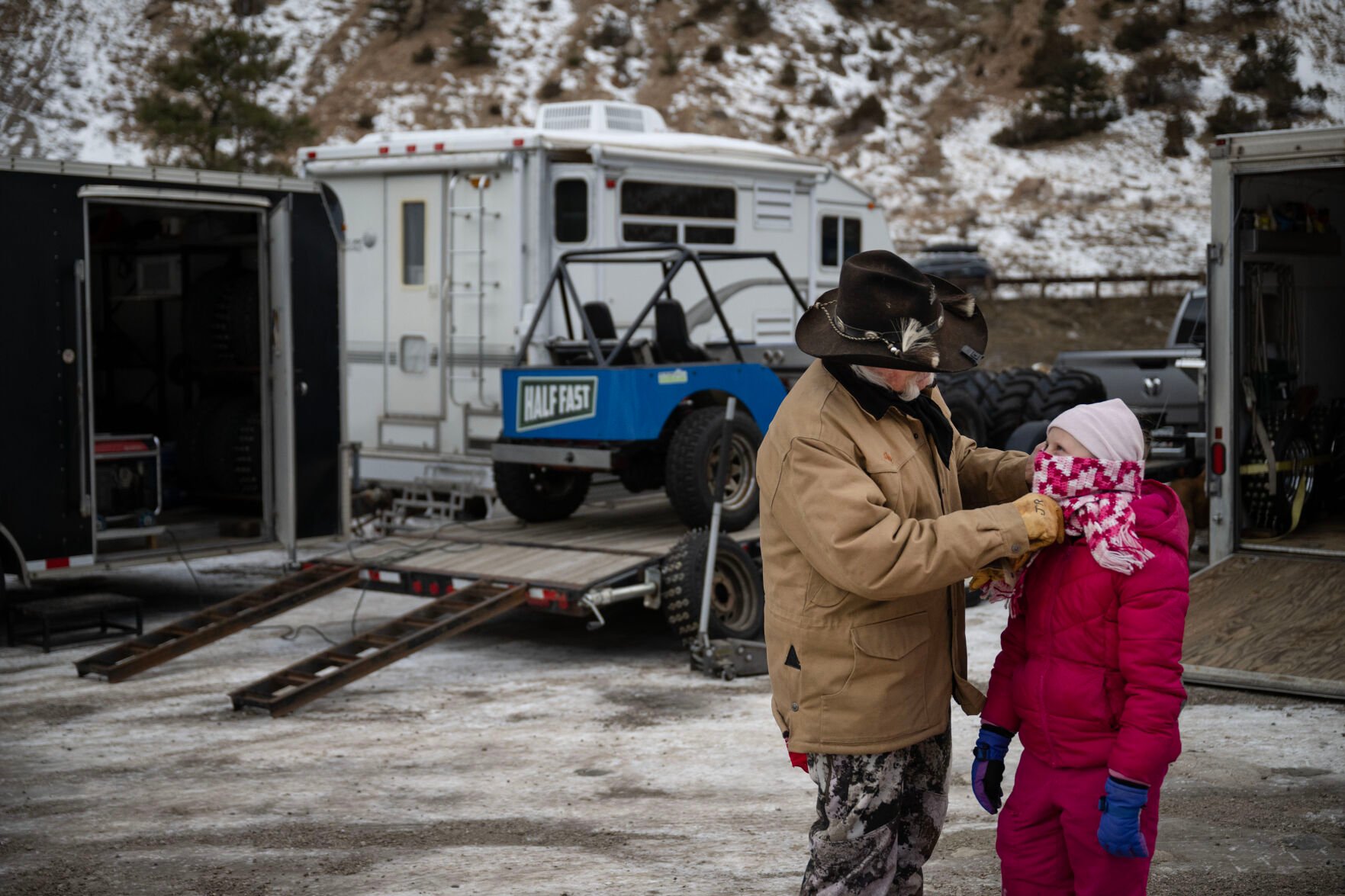JR Davis helps pull down his granddaughter Aspen Davis’, 9, scarf during the first day of the Our Gang 4 Wheelers ice racing club’s 2023 racing season on Saturday, Jan. 7, 2023, in Georgetown. (Timothy Hurst, The Gazette)