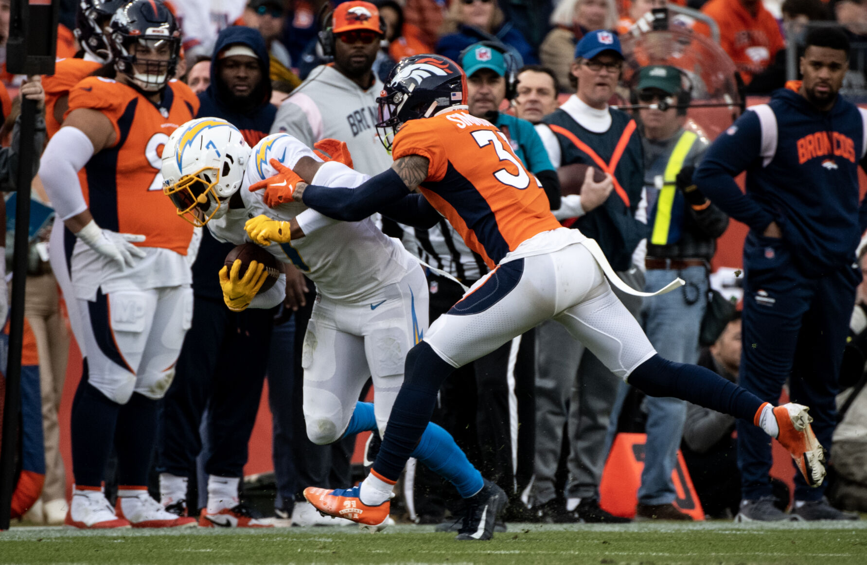 Denver Broncos safety Justin Simmons (31) pushes Los Angeles Chargers tight end Gerald Everett (7) out of bounds in the first half of the last regular season game Sunday, Jan. 8, 2023 at Empower Field at Mile High in Denver. (Parker Seibold, The Gazette) (Parker Seibold)