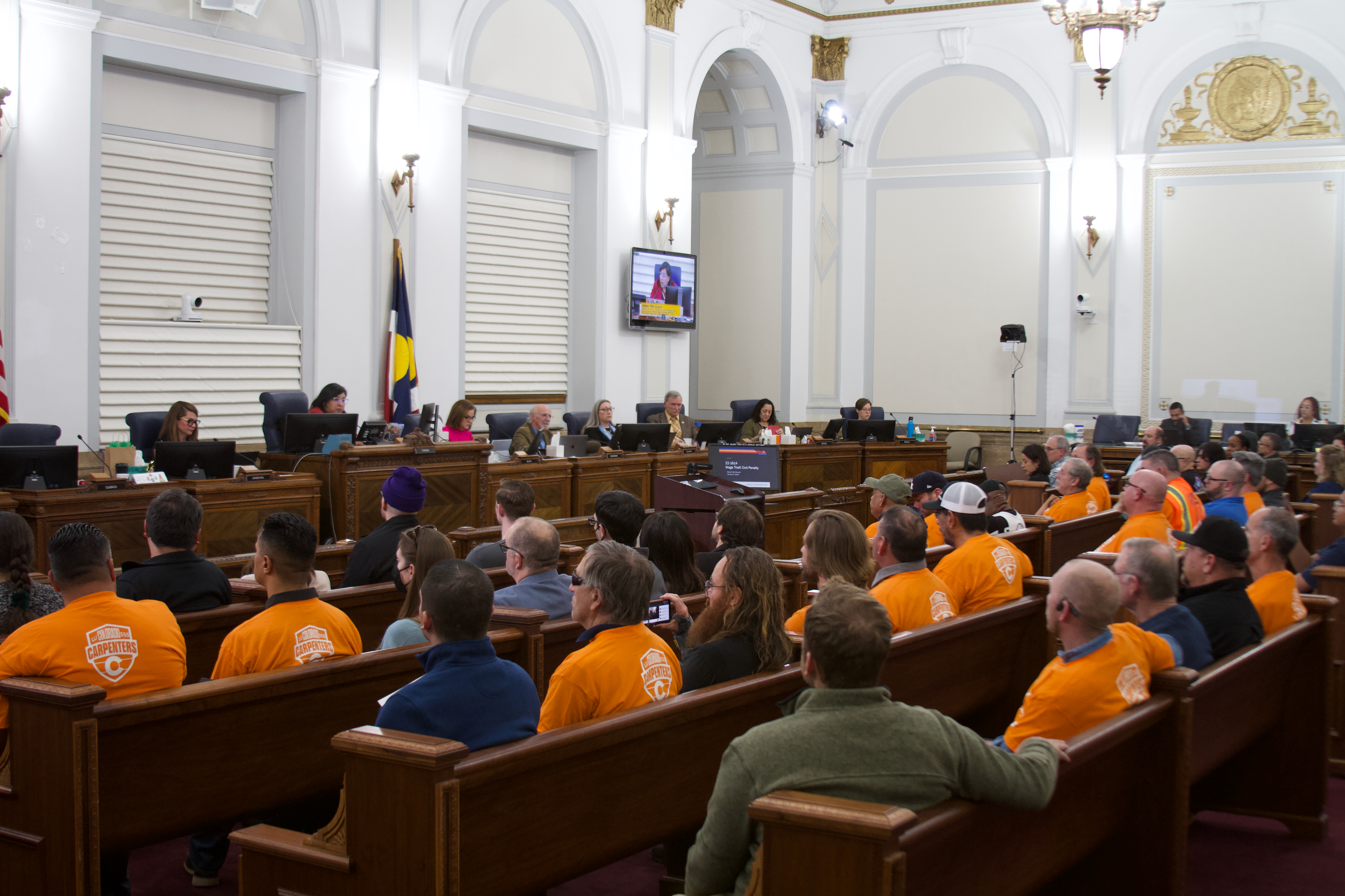 A sea of orange fills the Council Chambers as City Council considered a bill increasing wage theft protections. The bill passed unanimously. (Alex Edwards/The Denver Gazette) (ALEX EDWARDS/THE DENVER GAZETTE)