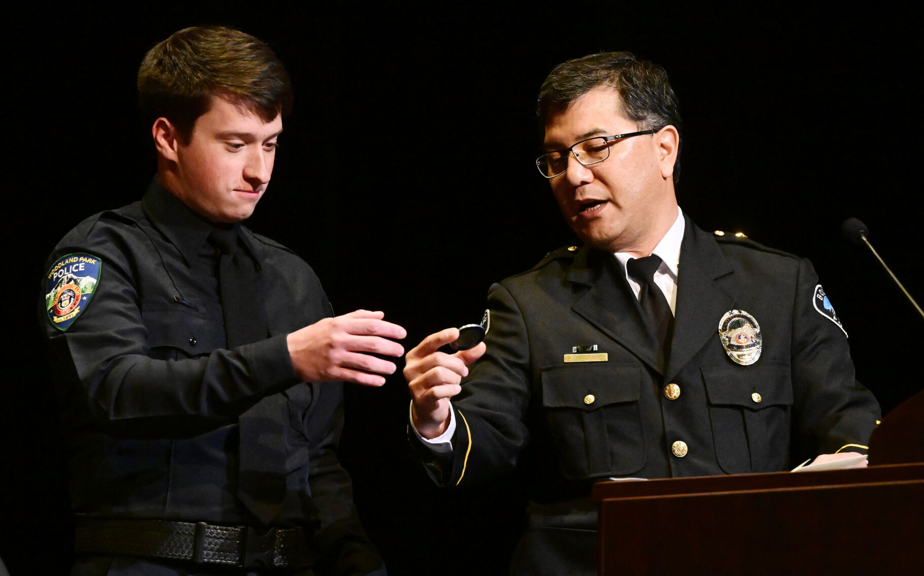 Boulder Police Department Cmdr. Kerry Yamaguchi, right, came from Boulder to present Sam Dunbar with a commemorative medal for Officer Eric Talley on Thursday. Talley was killed in the King Soopers shootings in Boulder and inspired Dunbar to become a policeman. Dunbar was graduating from a program with Pikes Peak State College. Dunbar was sworn into the Woodland Park Police Department during the ceremony. (Jerilee Bennett, The Gazette)
