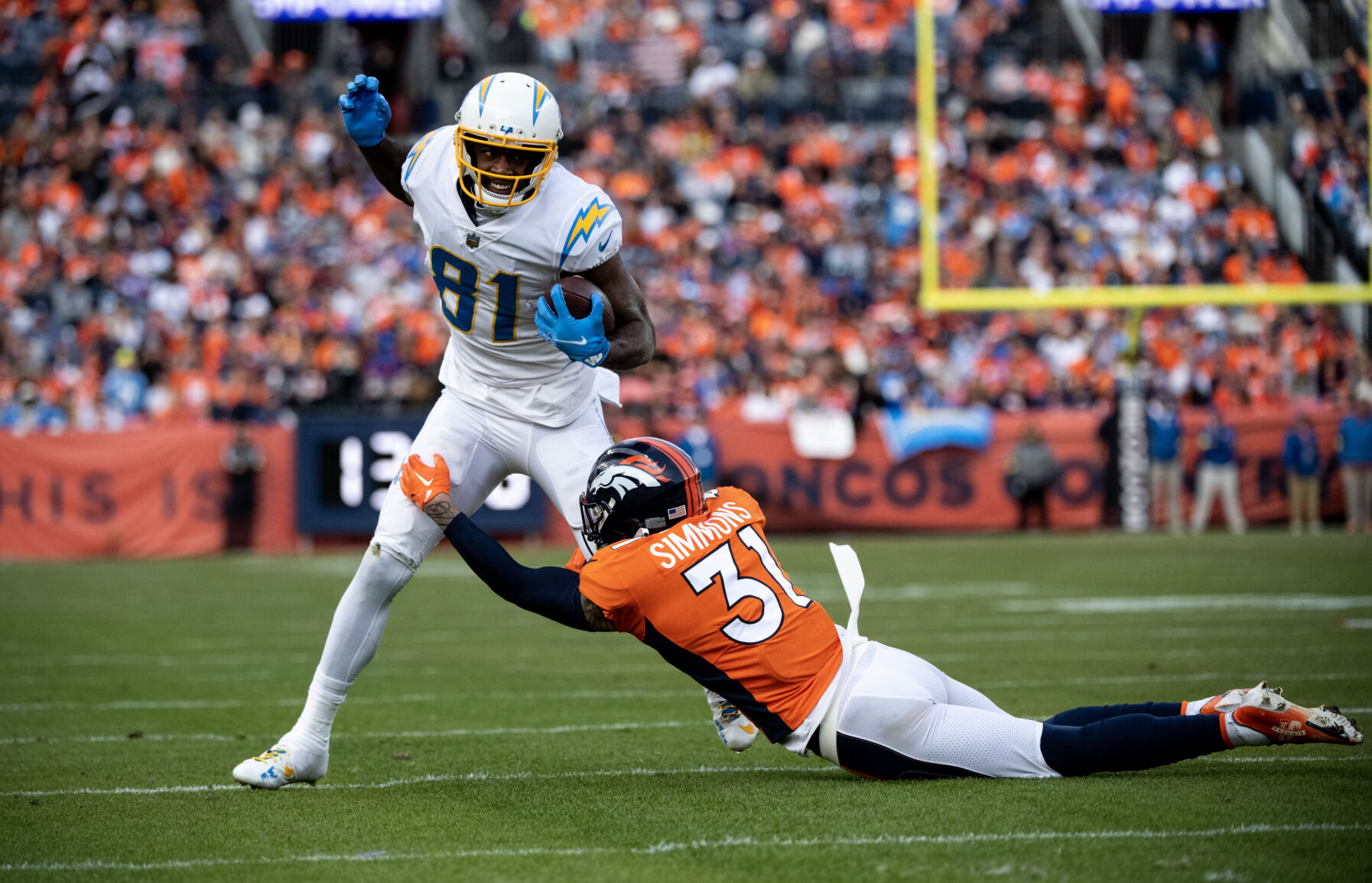 Denver Broncos safety Justin Simmons (31) tackles Los Angeles Chargers wide receiver Mike Williams (81) in the first half of the last regular season game Sunday, Jan. 8, 2023 at Empower Field at Mile High in Denver. (Parker Seibold, The Gazette) (Parker Seibold)
