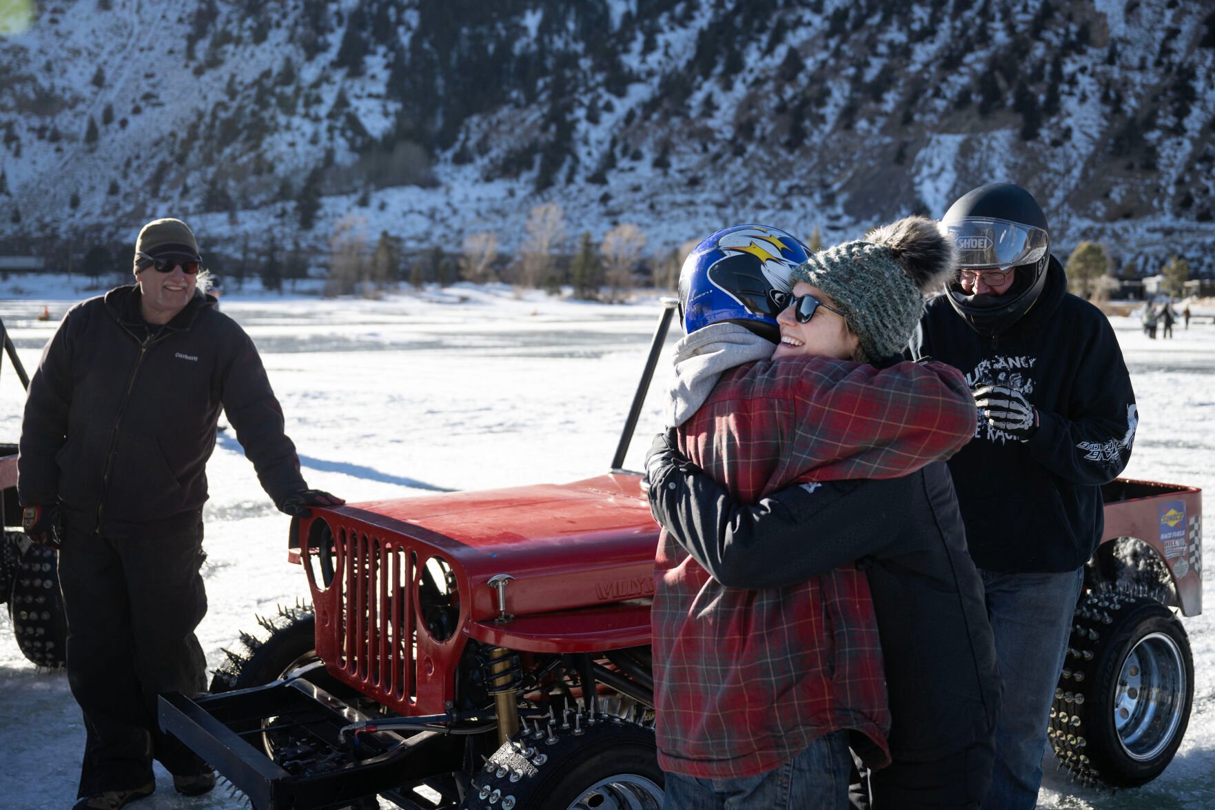 Men’s Competition Cheaters race winner Lee Bashline, left, hugs his daughter, and winner of the Women’s Competition Cheaters race, Lindsey Johansen, after winning the last race of the day during the first day of the Our Gang 4 Wheelers ice racing club’s 2023 racing season on Saturday, Jan. 7, 2023, in Georgetown, Colo. The Cheater division is named for the tires used, which have 1 1/2 inch sharpened bolts protruding from them. (Timothy Hurst/The Denver Gazette) (TIMOTHY HURST/DENVER GAZETTE)