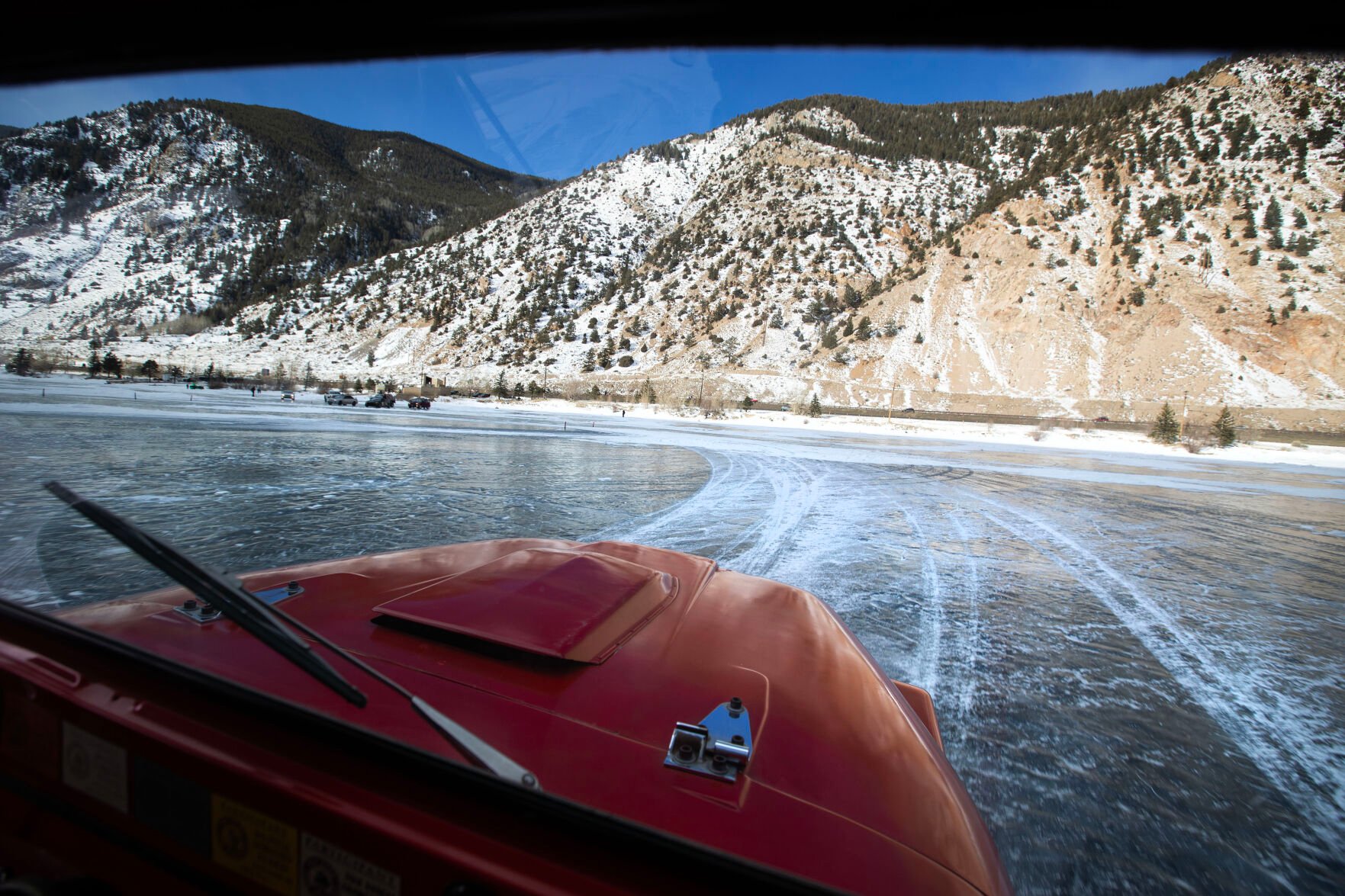 The sun comes out over the lake while Cody Ling takes a practice lap before the start of the first day of the Our Gang 4 Wheelers ice racing club’s 2023 racing season on Saturday, Jan. 7, 2023, in Georgetown, Colo.(Timothy Hurst/The Denver Gazette) (TIMOTHY HURST/DENVER GAZETTE)