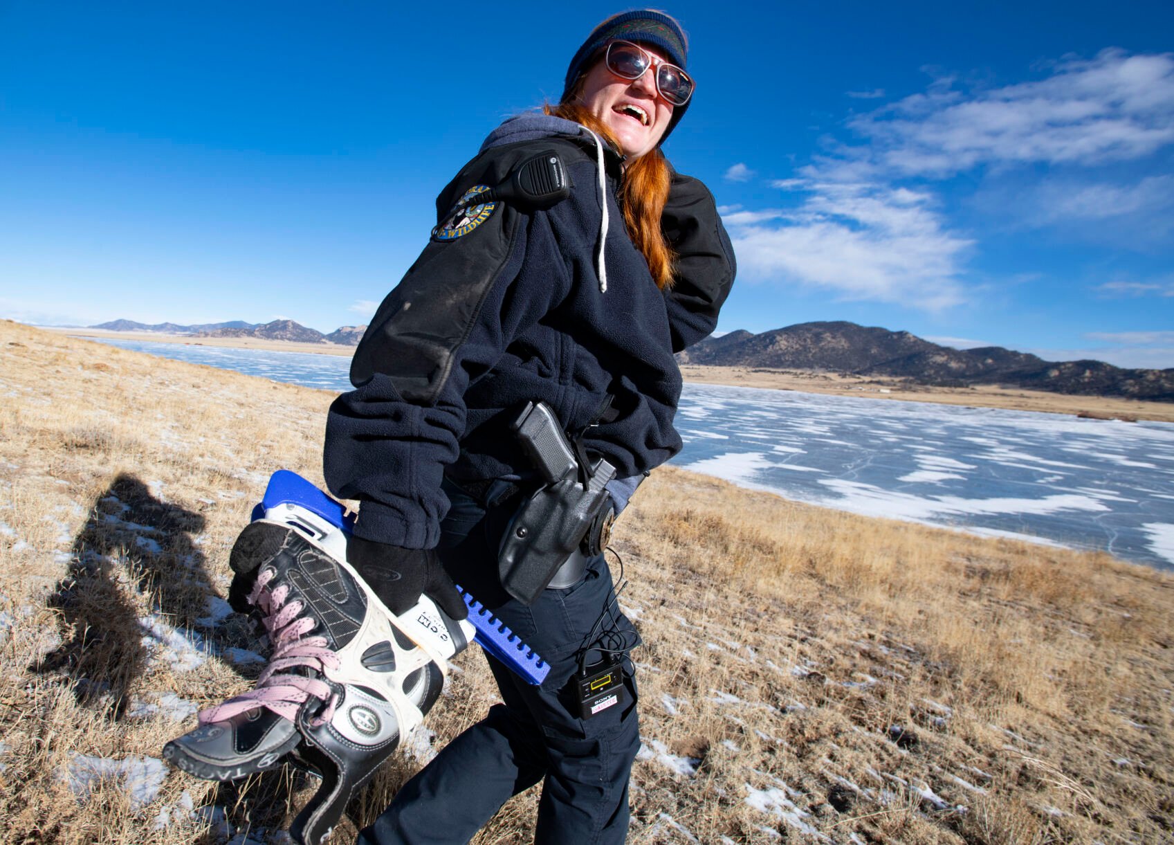 Colorado Parks and Wildlife ranger Kelli Lewis carries her ice skates with her as she walks down to Eleven Mile Reservoir to patrol early this month. Lewis started skating on the ice last year when a warm winter made the ice unsafe to patrol on a snowmobile. (Christian Murdock, The DENVER Gazette)