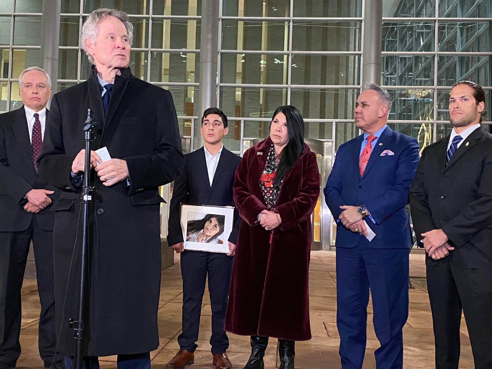 U.S. Attorney for the District of Colorado Cole Finegan addresses the press after his office got the longest sentence for a fentanyl-involved death in Colorado federal court. Behind him are 13 year old Daniel Romero and his grandmother, Andrea Thomas, who lost their mom and daughter Ashley Romero to fentanyl poisoning. (Carol McKinley)