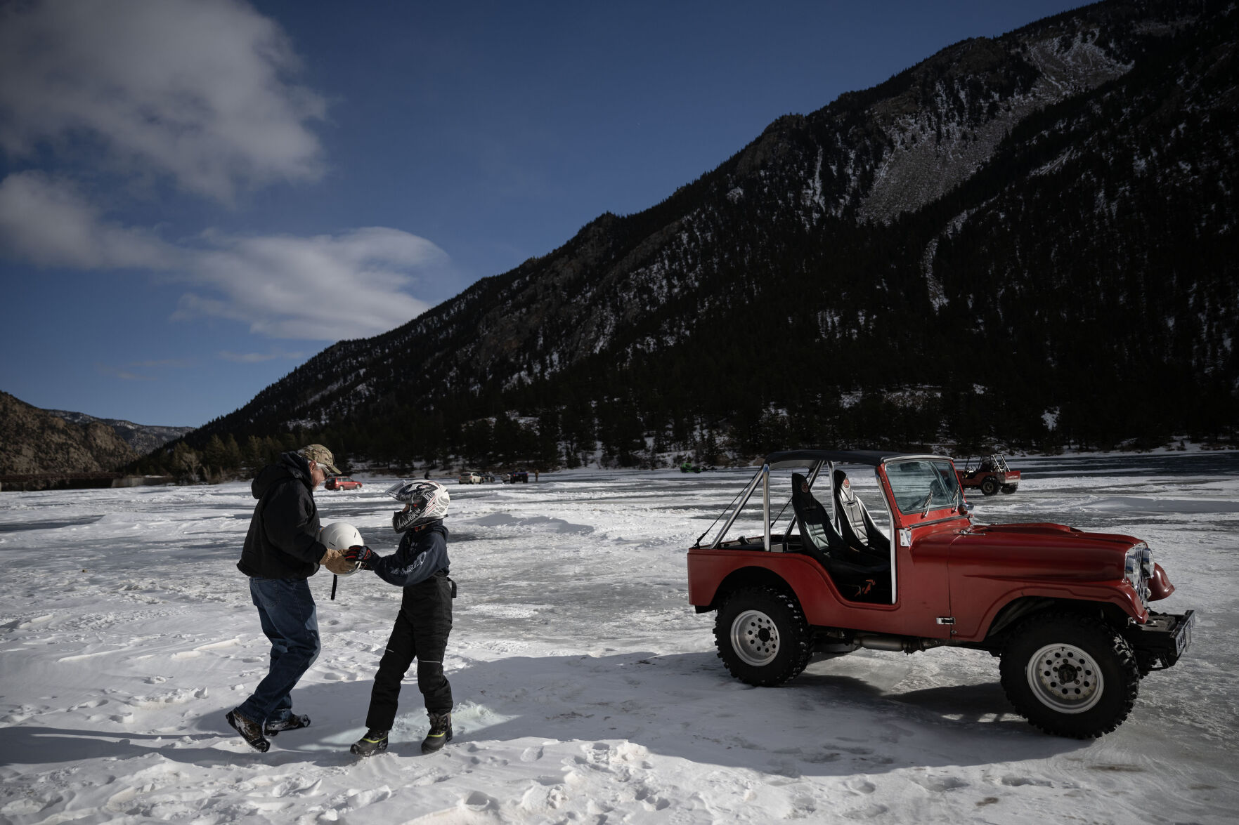 Cooper Altman, 12, hands his grandfather Dave Ling’s helmet to him before taking some practice laps in Ling’s 1976 fiberglass-bodied Jeep during the first day of the Our Gang 4 Wheelers ice racing club’s 2023 racing season on Jan. 7 in Georgetown. (TimHursttim.hurst@gazette.comhttps://secure.gravatar.com/avatar/aca82bd62b4ee425c598527cd6faa1b1?d=mm&r=g)