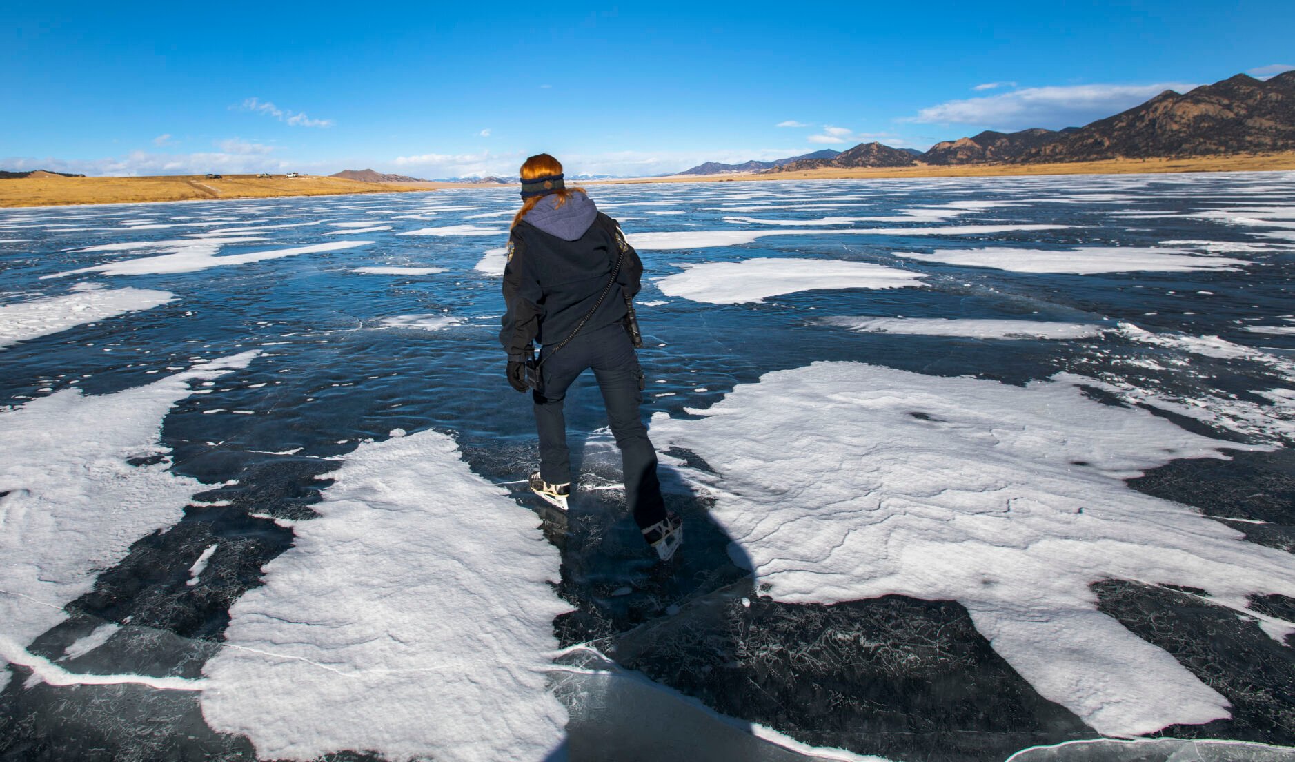 Park ranger Kelli Lewis wears her old pair of hockey skates while on patrol at Eleven Mile Reservoir. Lewis started skating on the ice last year when a warm winter made it unsafe to patrol on a snowmobile. (Christian Murdock, The denver Gazette)
