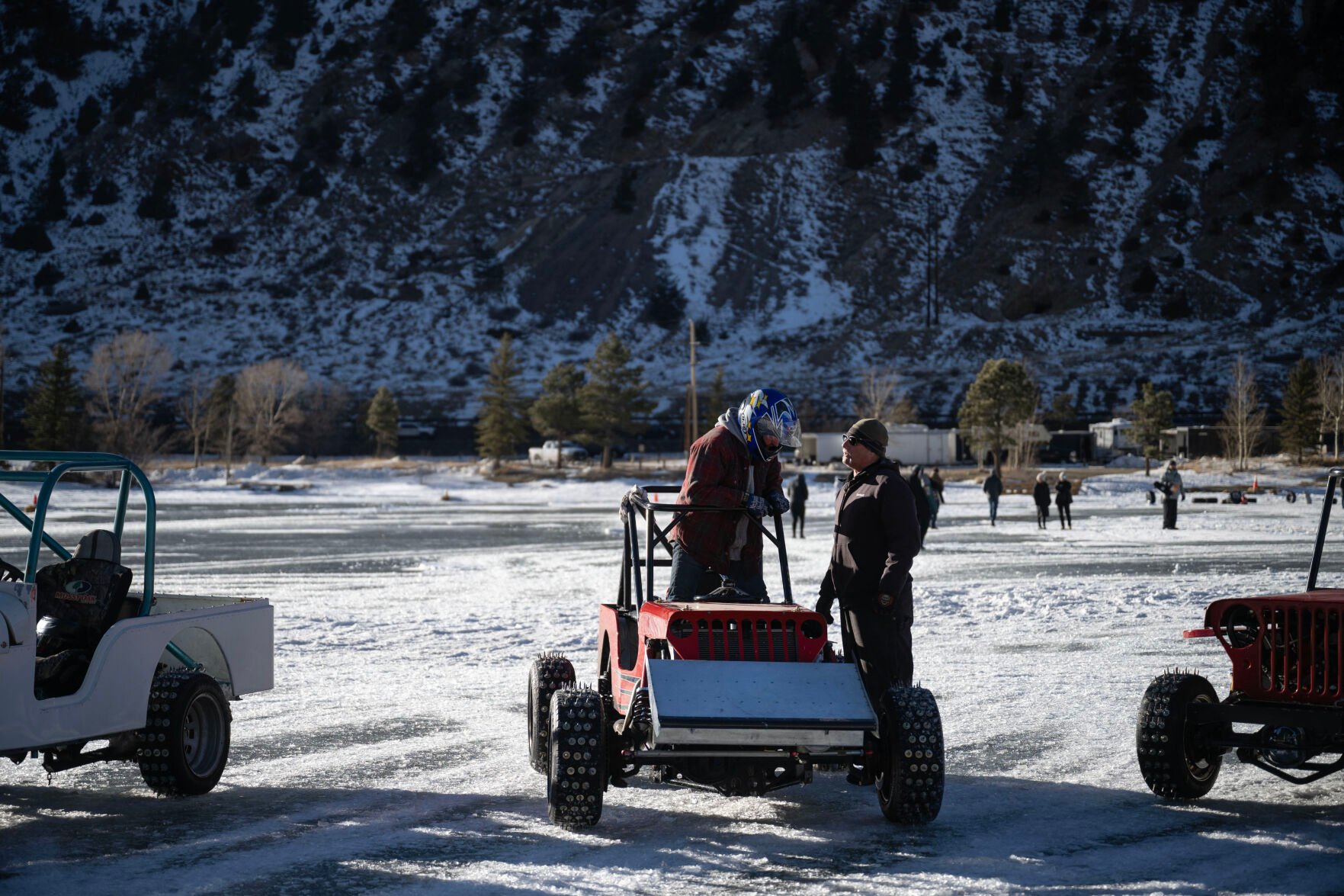 Men’s Competition Cheaters race winner Lee Bashline is greeted by fellow driver Dan O'Mary after the final race of the day at the Our Gang 4 Wheelers ice racing club’s 2023 racing season-opening day on Saturday, Jan. 7, 2023, in Georgetown, Colo. The Cheater division is named for the tires used, which have 1 1/2 inch sharpened bolts protruding from them. (Timothy Hurst/The Denver Gazette) (TIMOTHY HURST/DENVER GAZETTE)